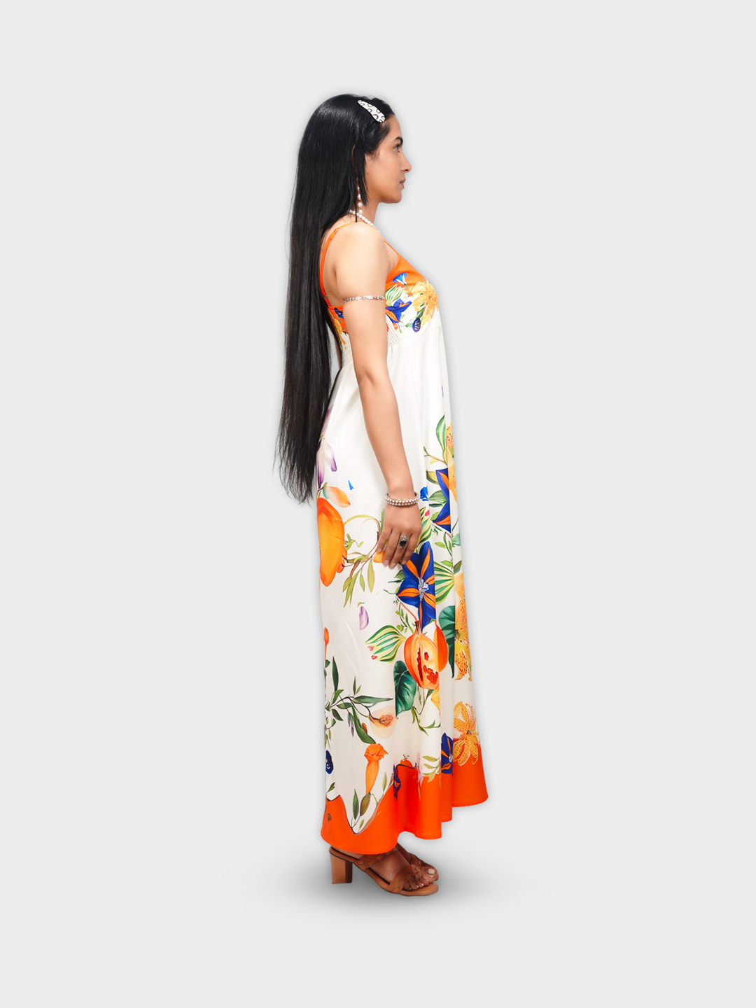 Woman wearing a floral dress with orange accents on