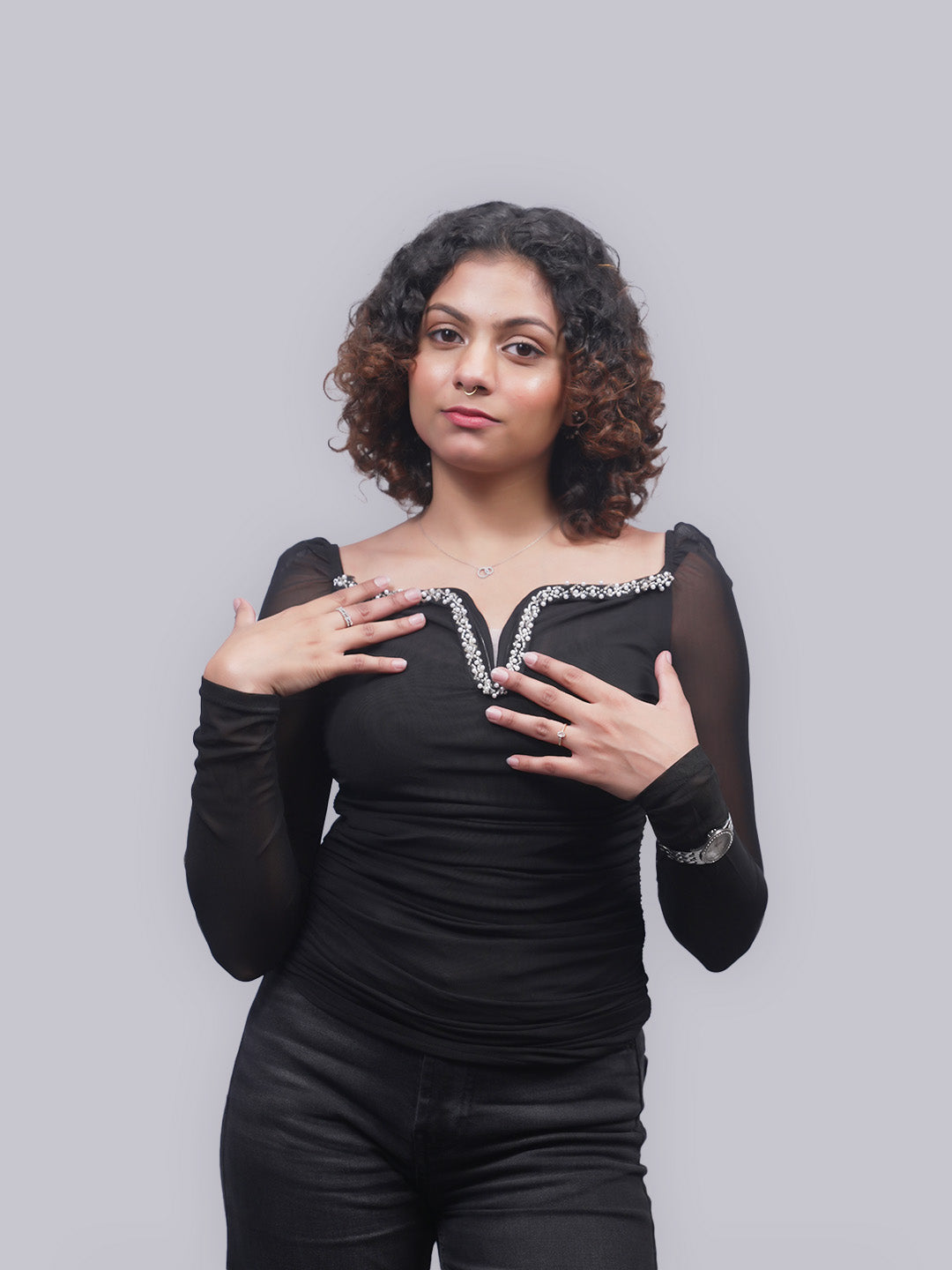 A woman with wearing a black long-sleeve top.