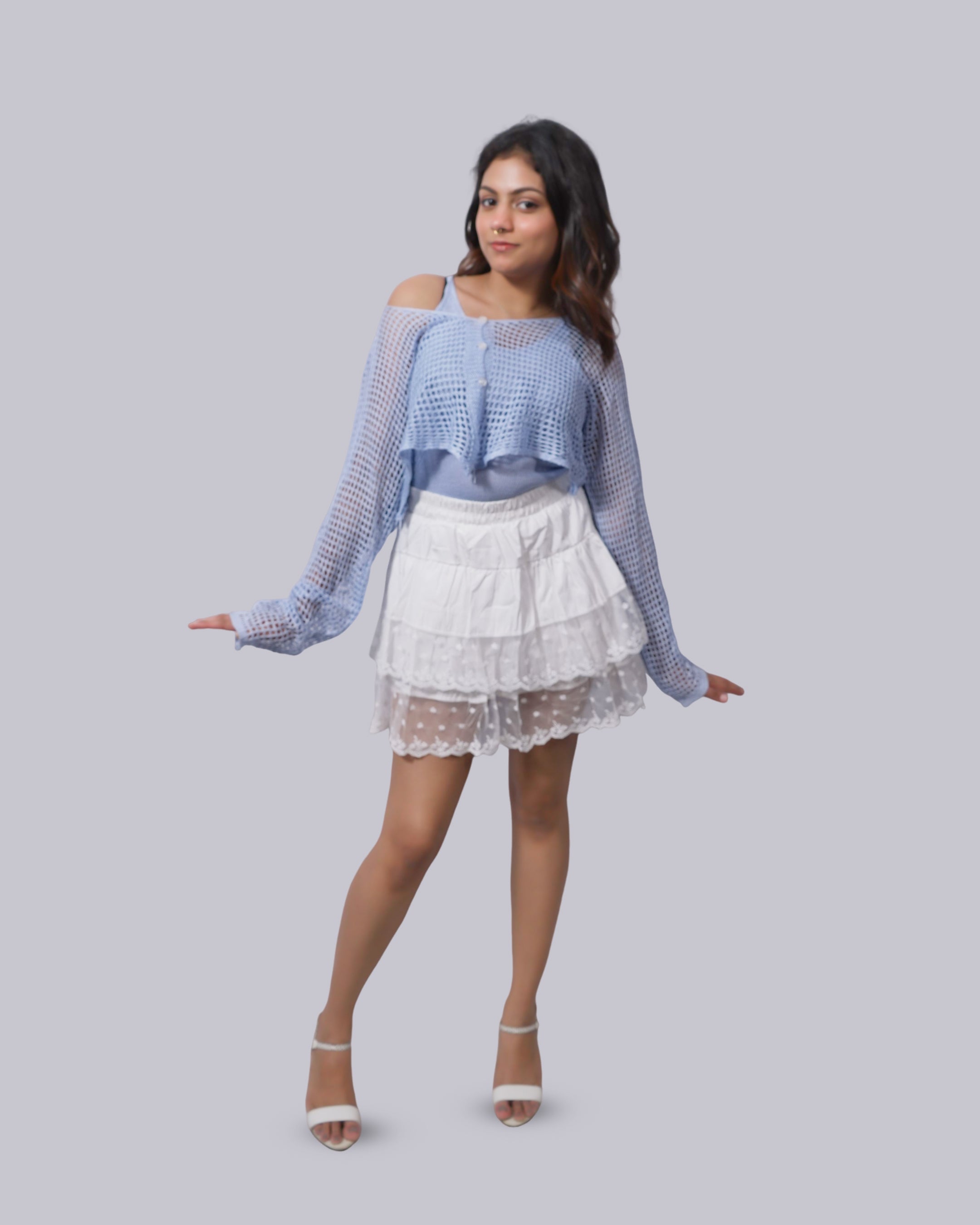 long sleeves and a white tiered ruffled mini skirt.