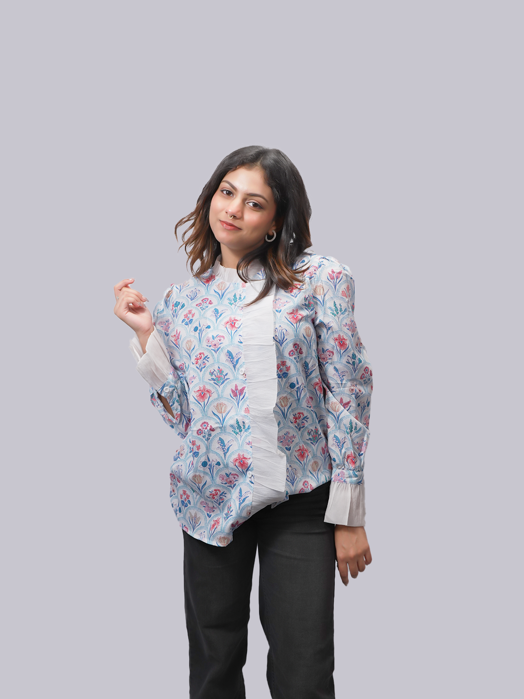 A woman modeling a long-sleeve floral print blouse.