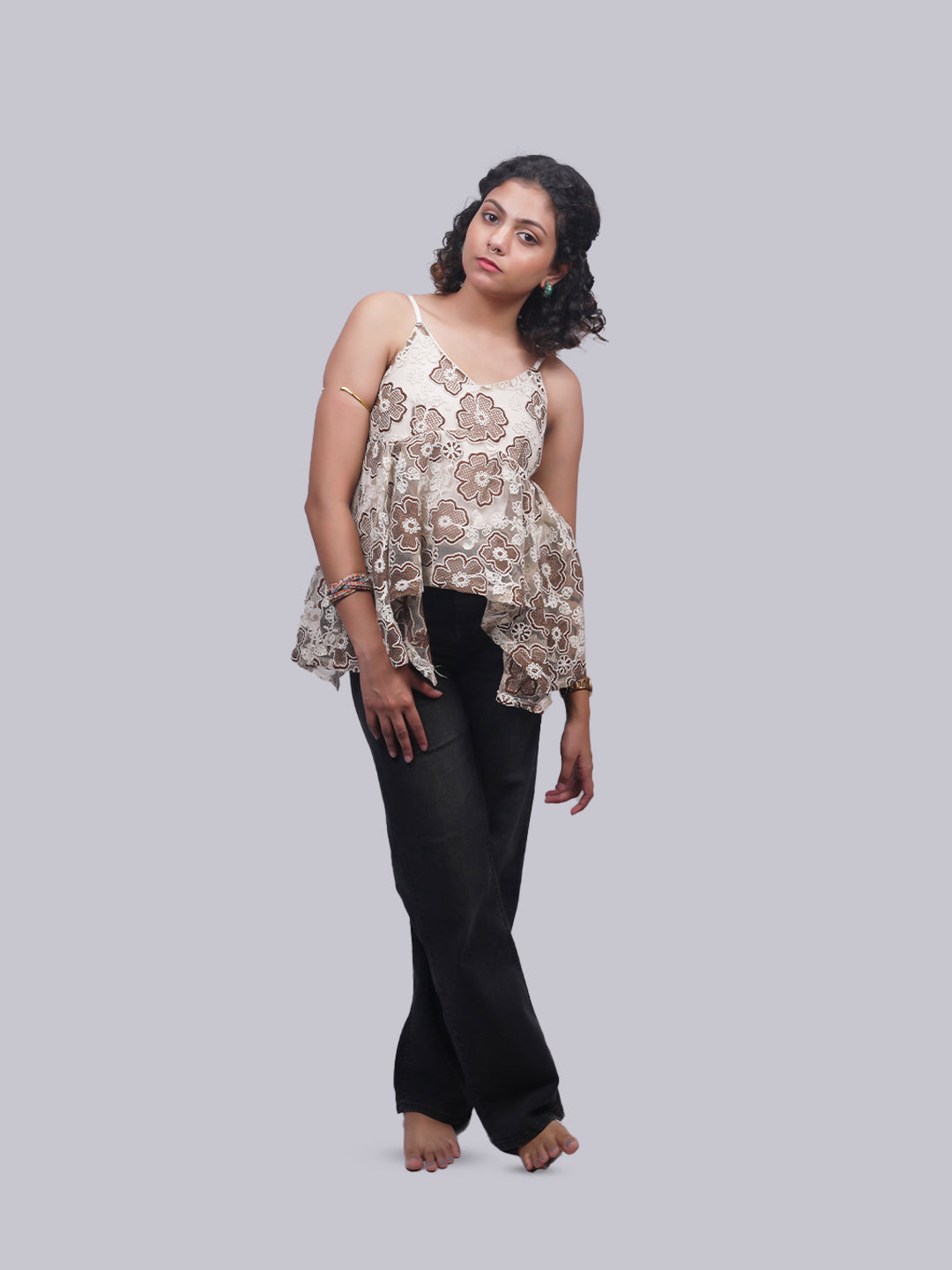 A sleeveless beige and brown floral print top.