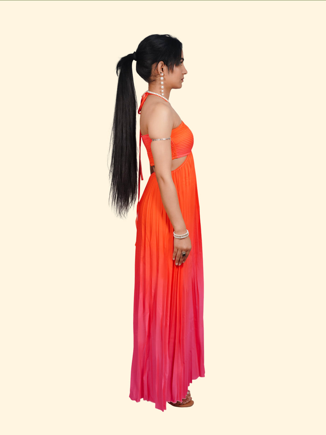 Woman wearing an orange to pink gradient dress on a white background