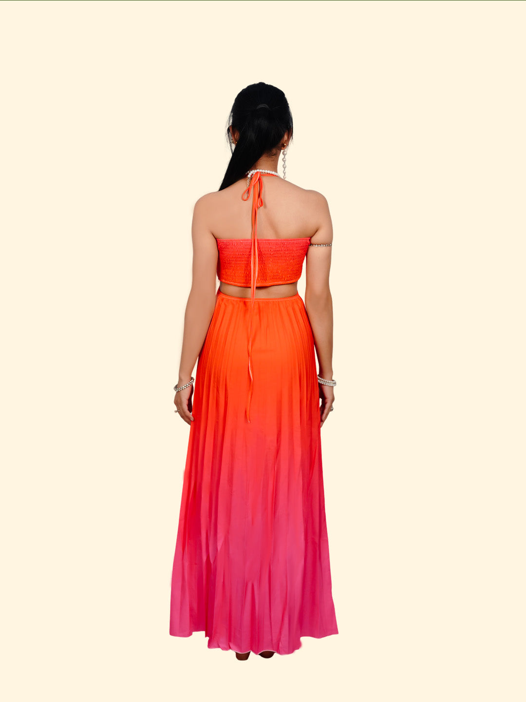 Woman wearing a colorful dress with a gradient from orange