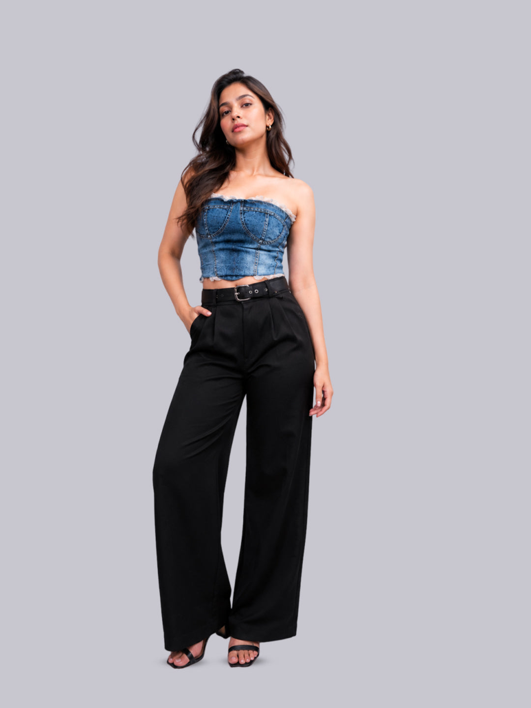 A woman modeling  high-waisted black wide-leg trousers