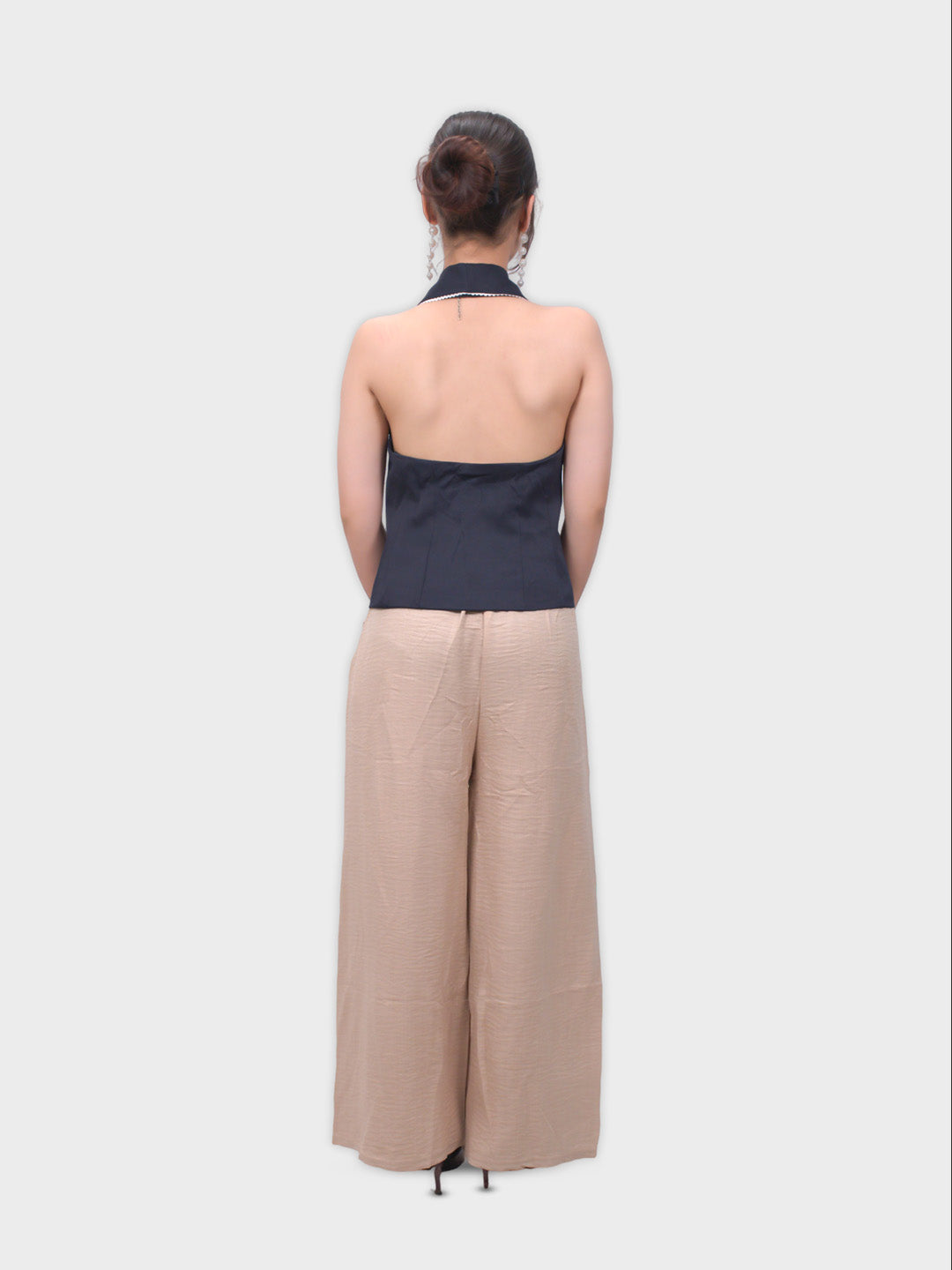 Woman wearing a navy top and beige pants