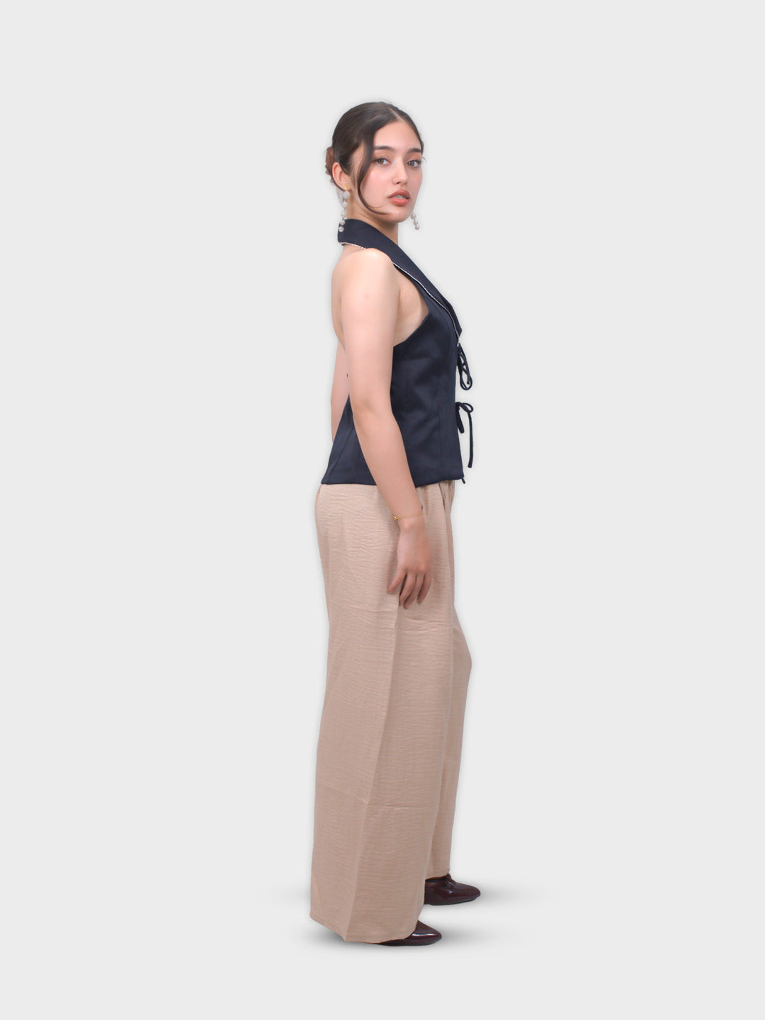 Woman wearing a navy top and beige pants