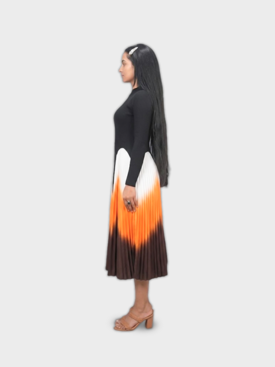 Woman wearing a black, orange, and brown gradient dress 
