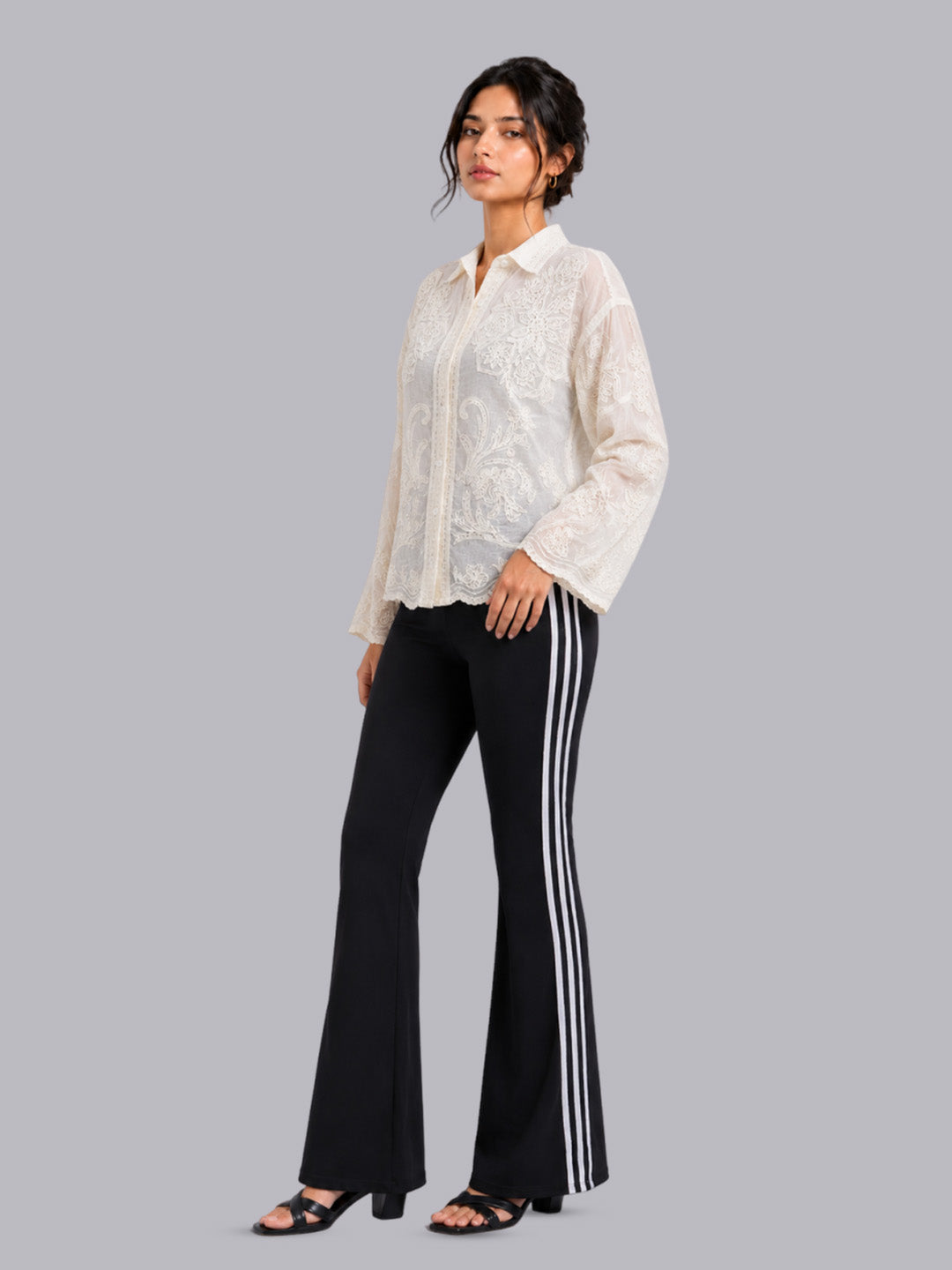 A white embroidered long-sleeve blouse.