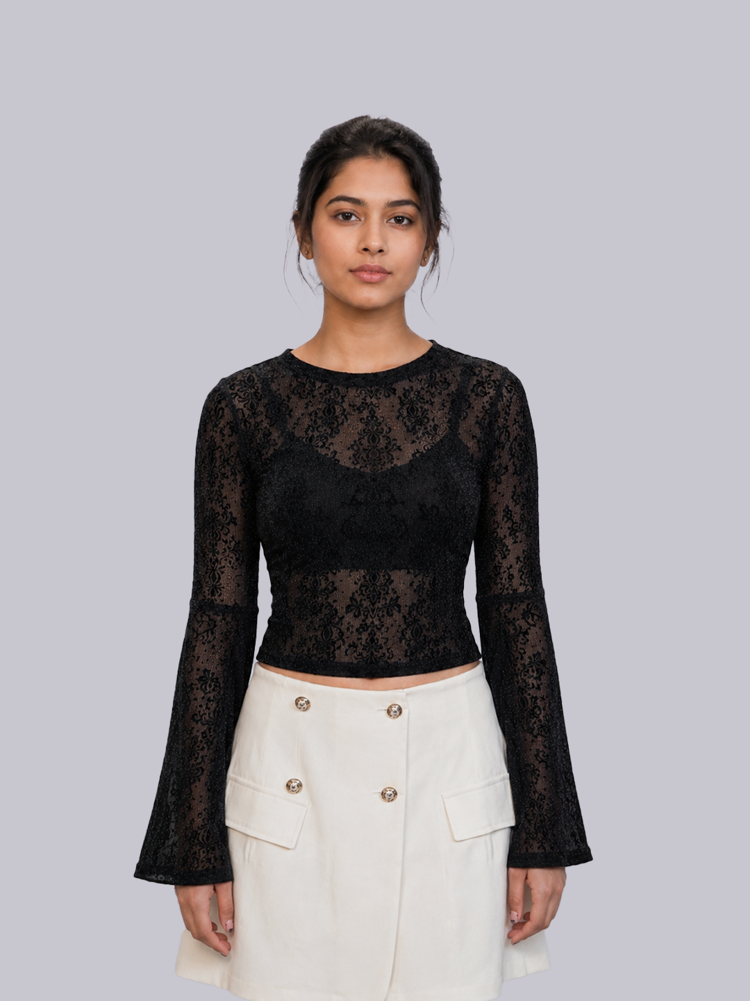 A woman modeling a black long-sleeve lace top with a crew neck.