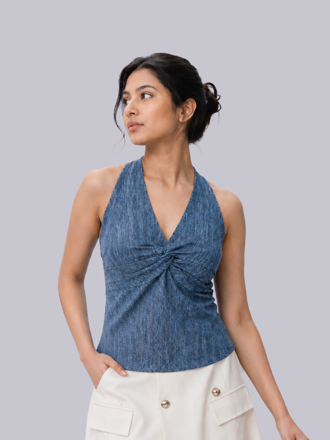 A woman modeling a sleeveless halter-style top with a twisted front.