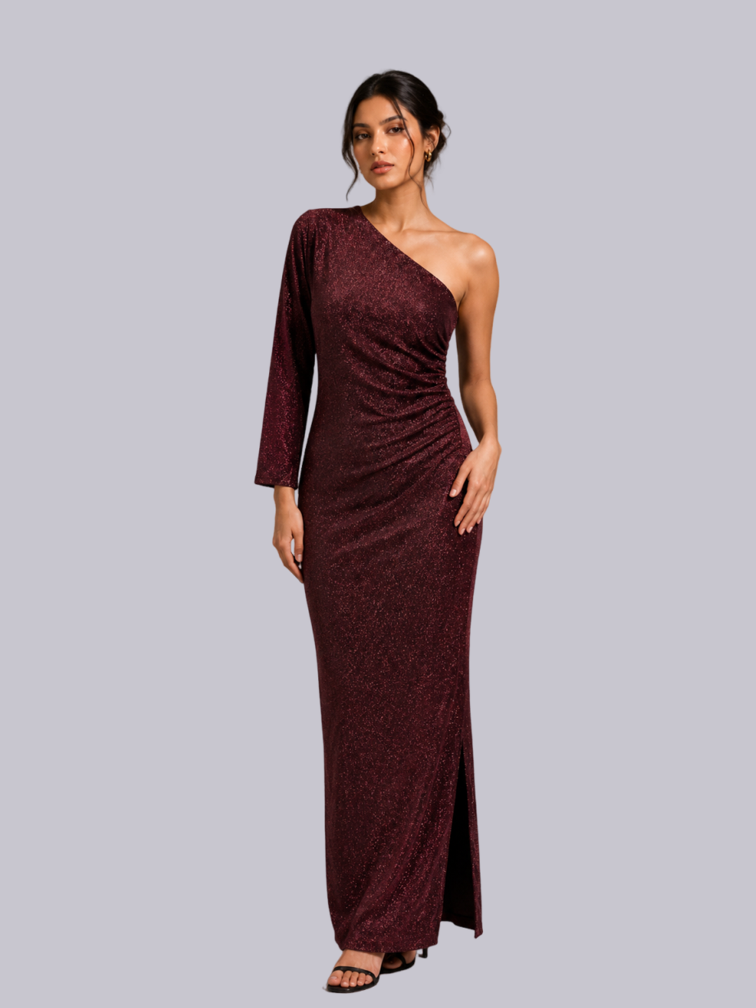 A woman modeling a floor-length, one-shoulder evening gown in a deep burgundy marbled fabric.