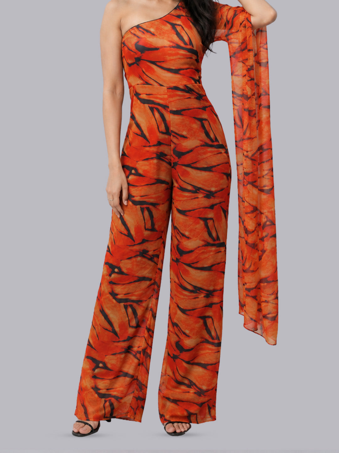 A one-shoulder jumpsuit with wide legs and a matching long scarf.
