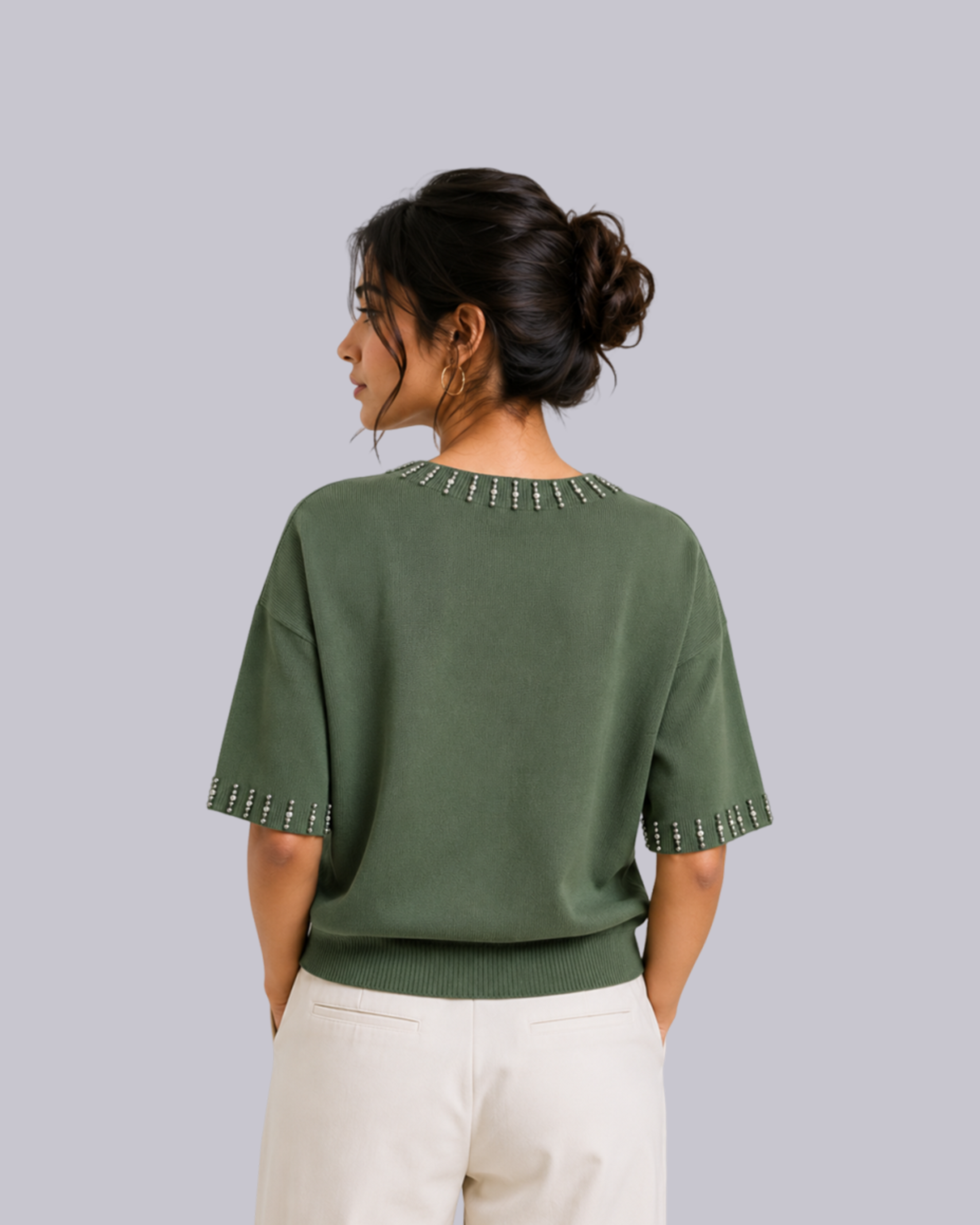 A woman shown from the back wearing an olive green short-sleeve knit top