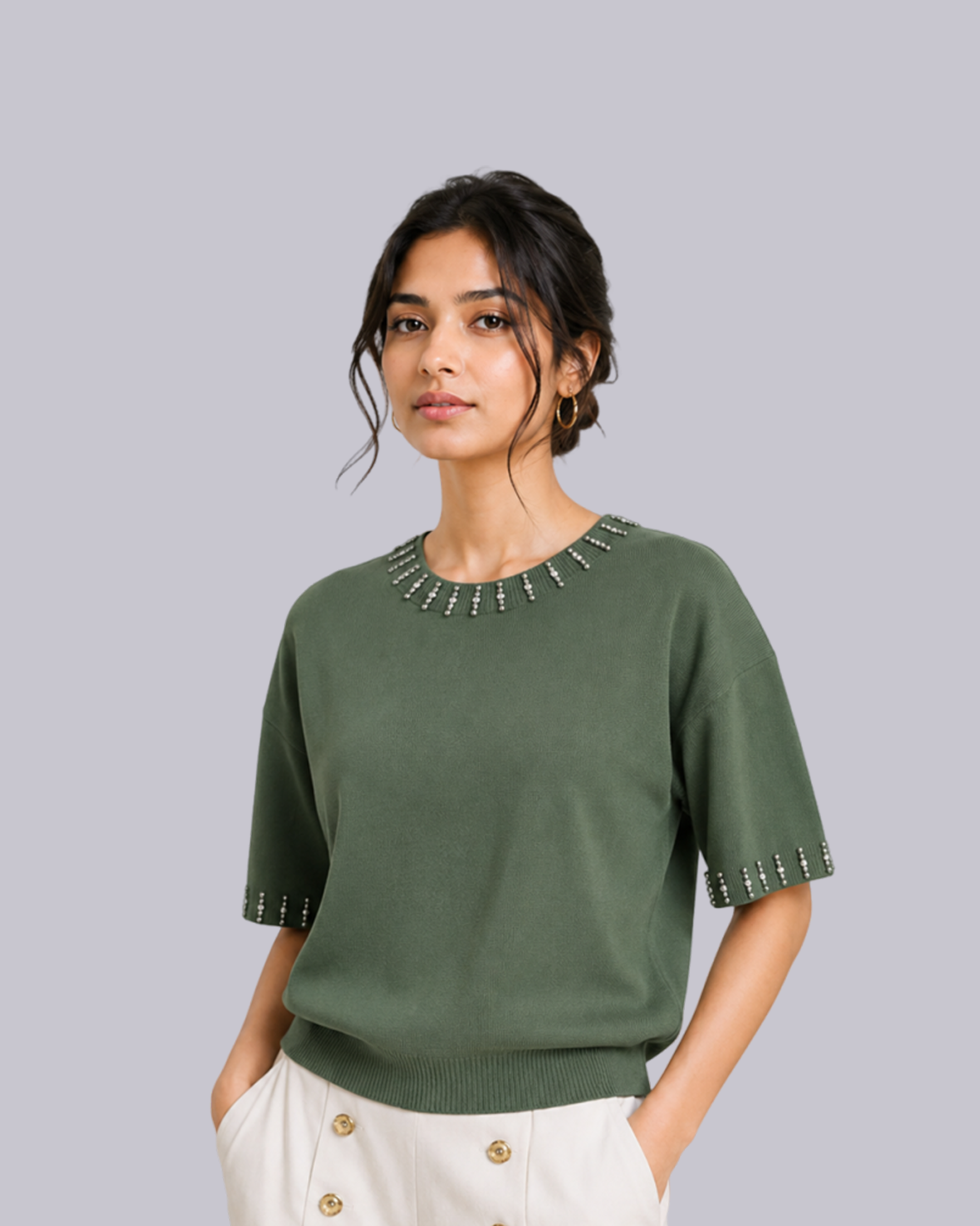 A woman wearing a sage green short-sleeve knit sweater