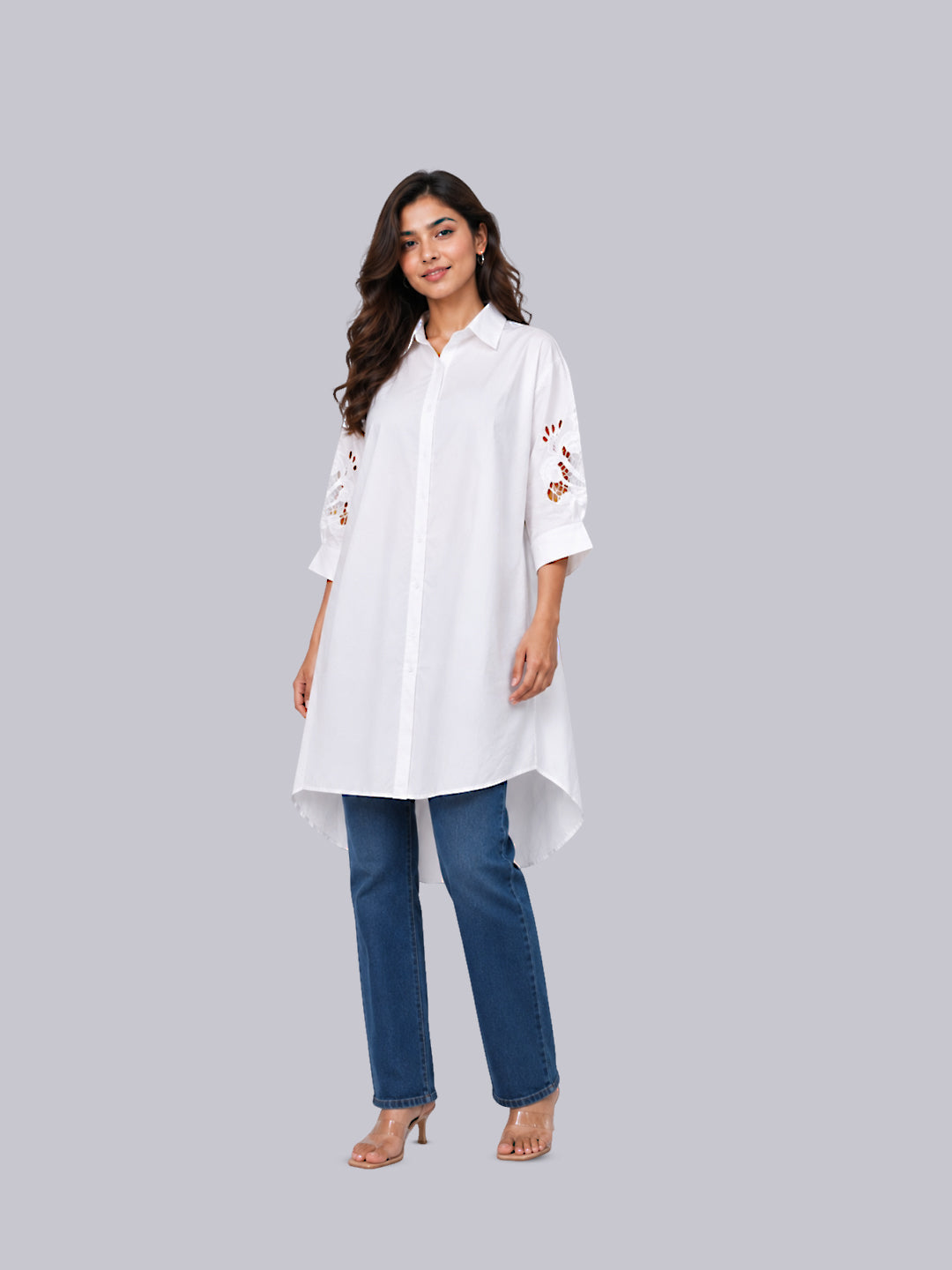 A white long-sleeve button-up tunic top with floral embroidery on the sleeves