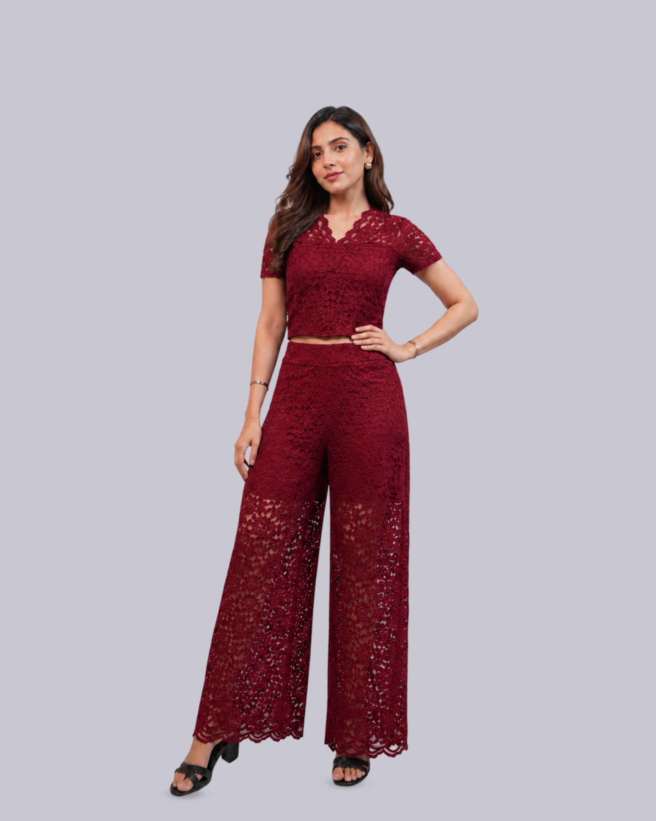 A woman modeling a matching deep red lace two-piece set.
