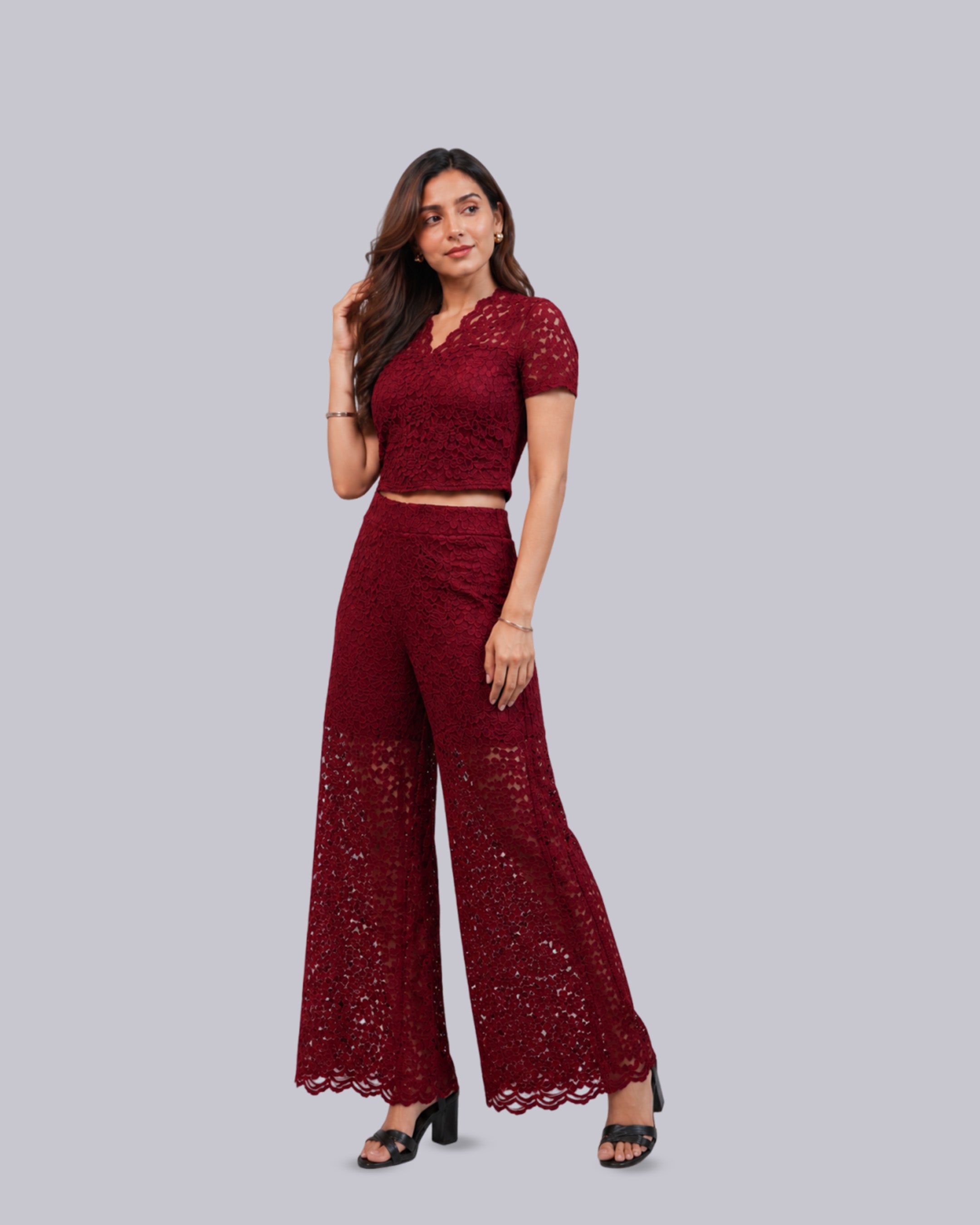 A woman modeling a matching deep red lace two-piece set.