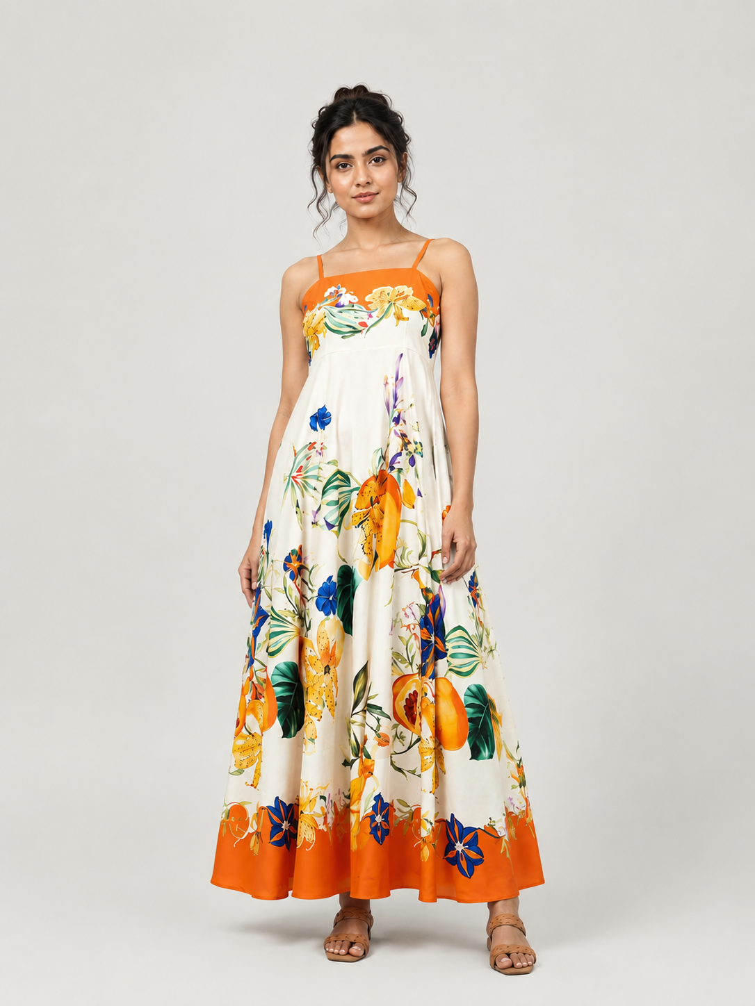 A sleeveless maxi dress with thin straps, featuring a white base