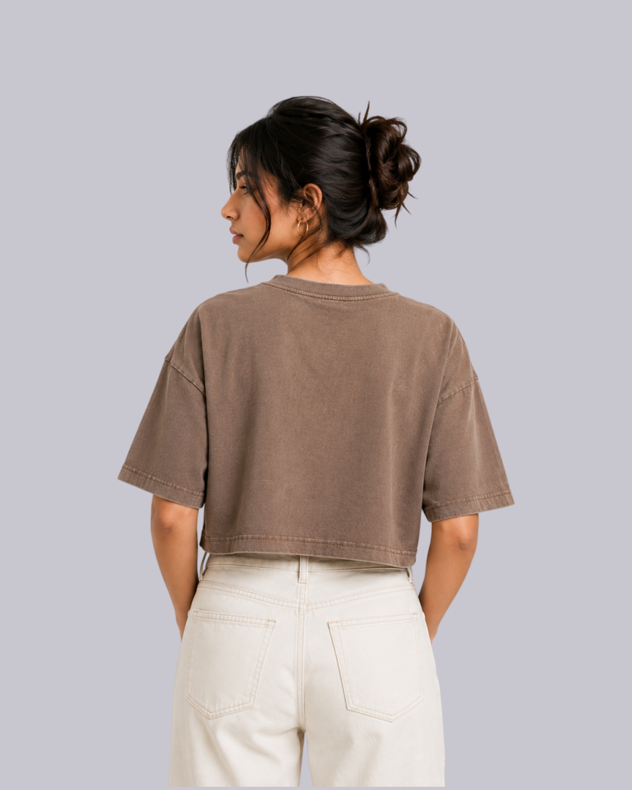 A woman shown from the back wearing a cropped, short-sleeve t-shirt