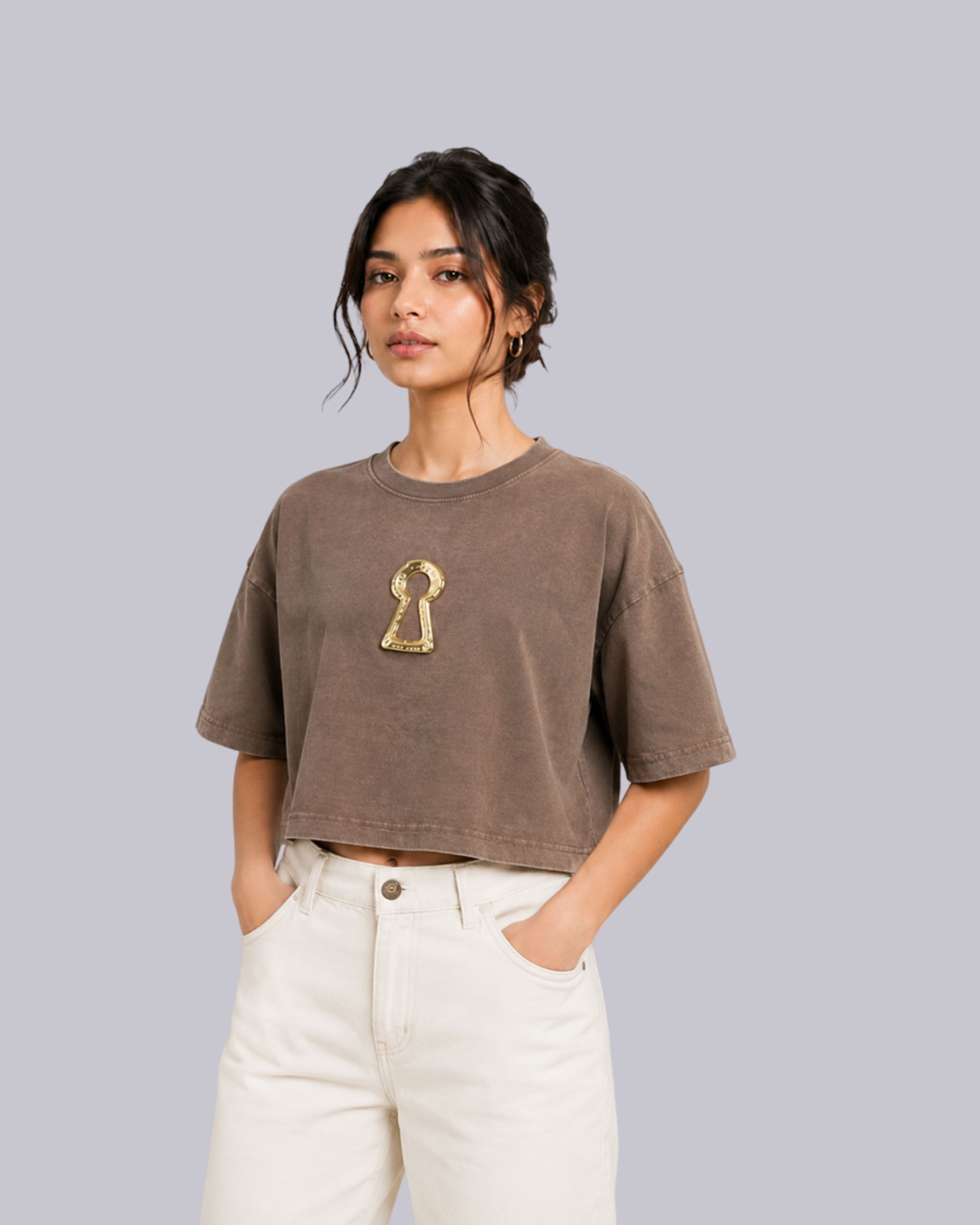 A woman modeling a cropped, acid-washed brown t-shirt