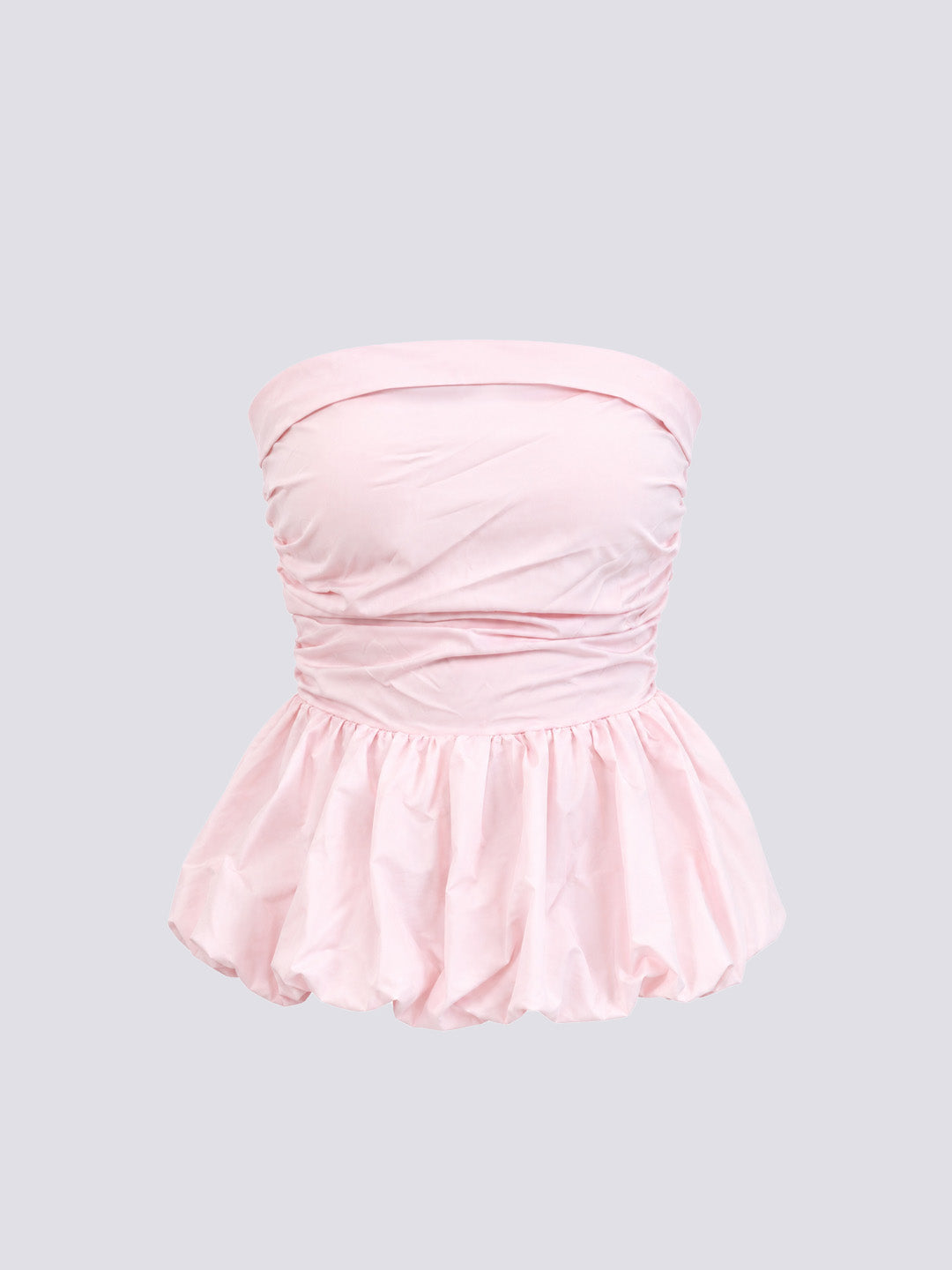 A light pink top with a ruched gathered bodice and a ruffled peplum hem.