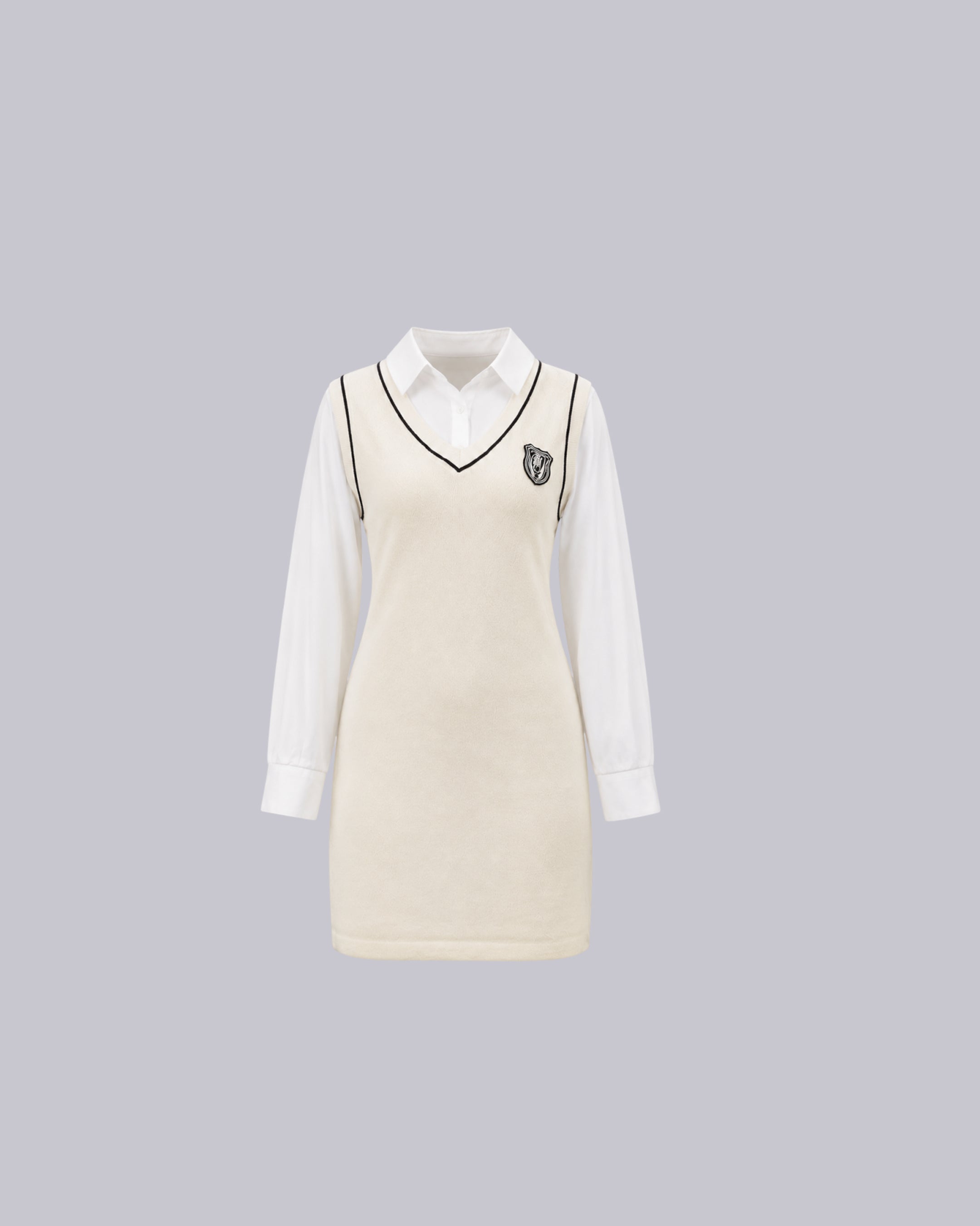 An off-white knit sweater vest with black trim.