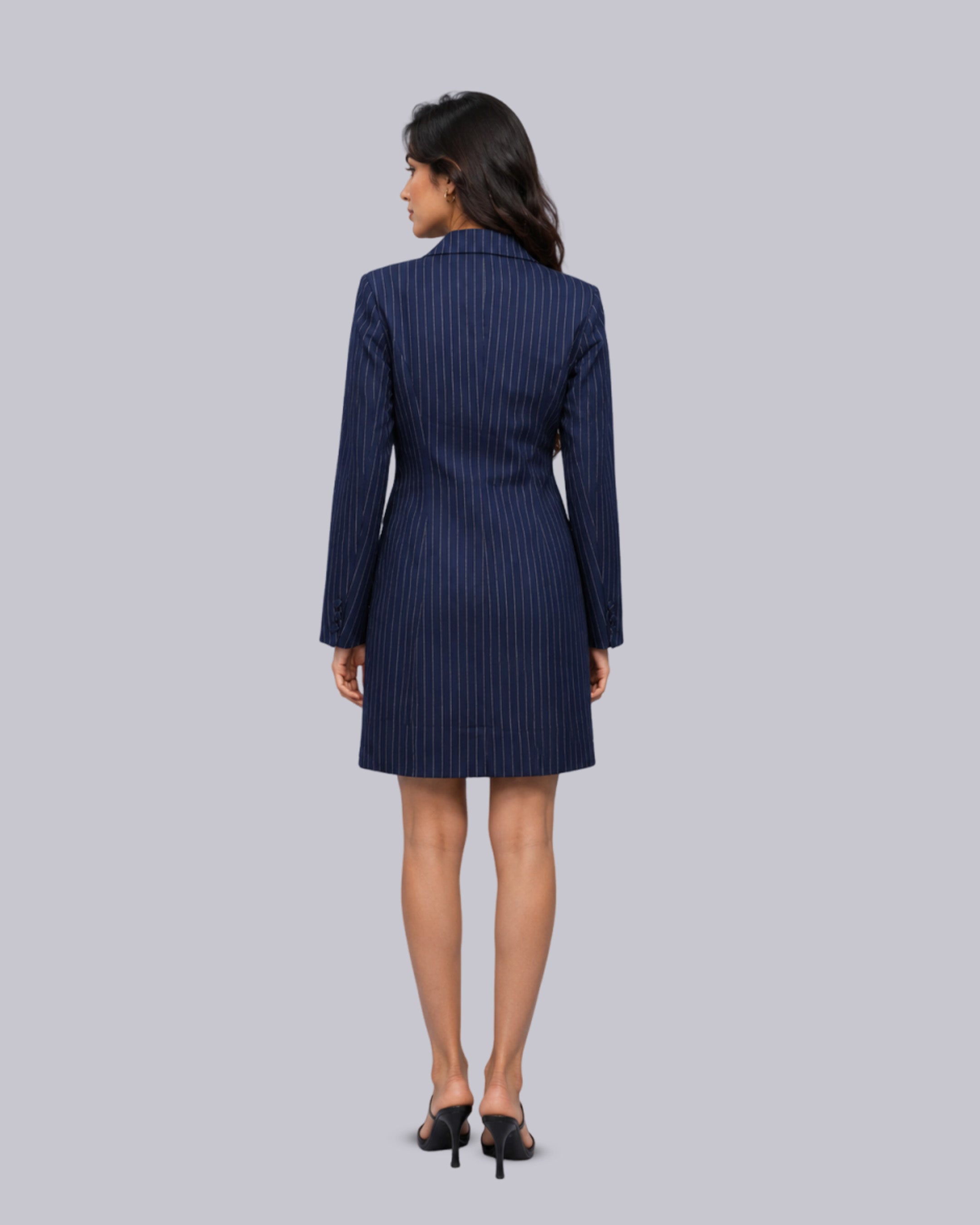 The back wearing a navy blue pinstriped blazer dress