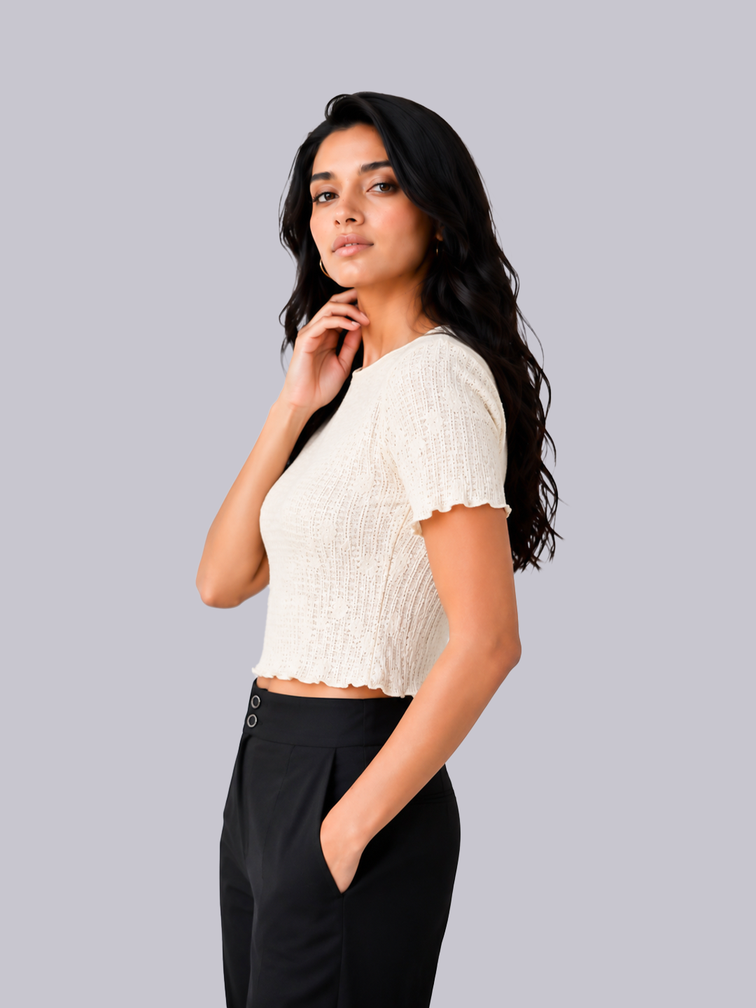 A woman modeling a short-sleeve cream ribbed knit crop top with a scalloped hem.