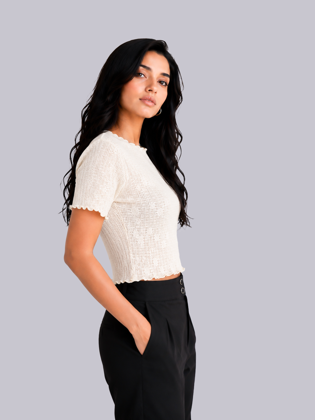 A woman with long, wavy black hair is shown from the waist up.