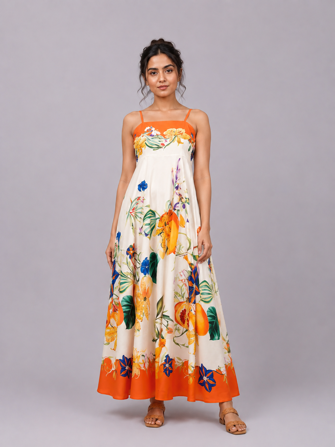 A sleeveless maxi dress with thin straps, featuring a cream base
