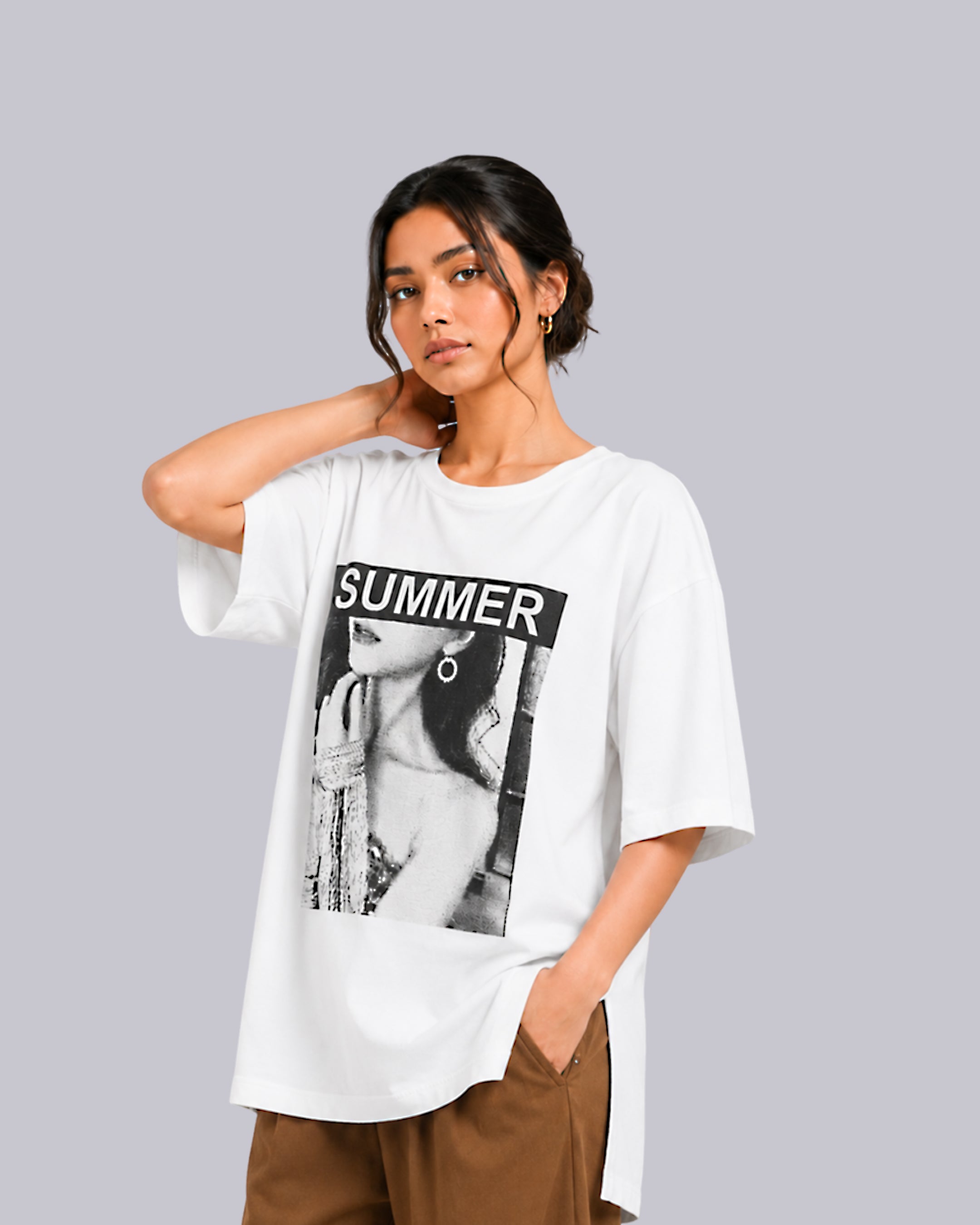A woman modeling an oversized white graphic t-shirt