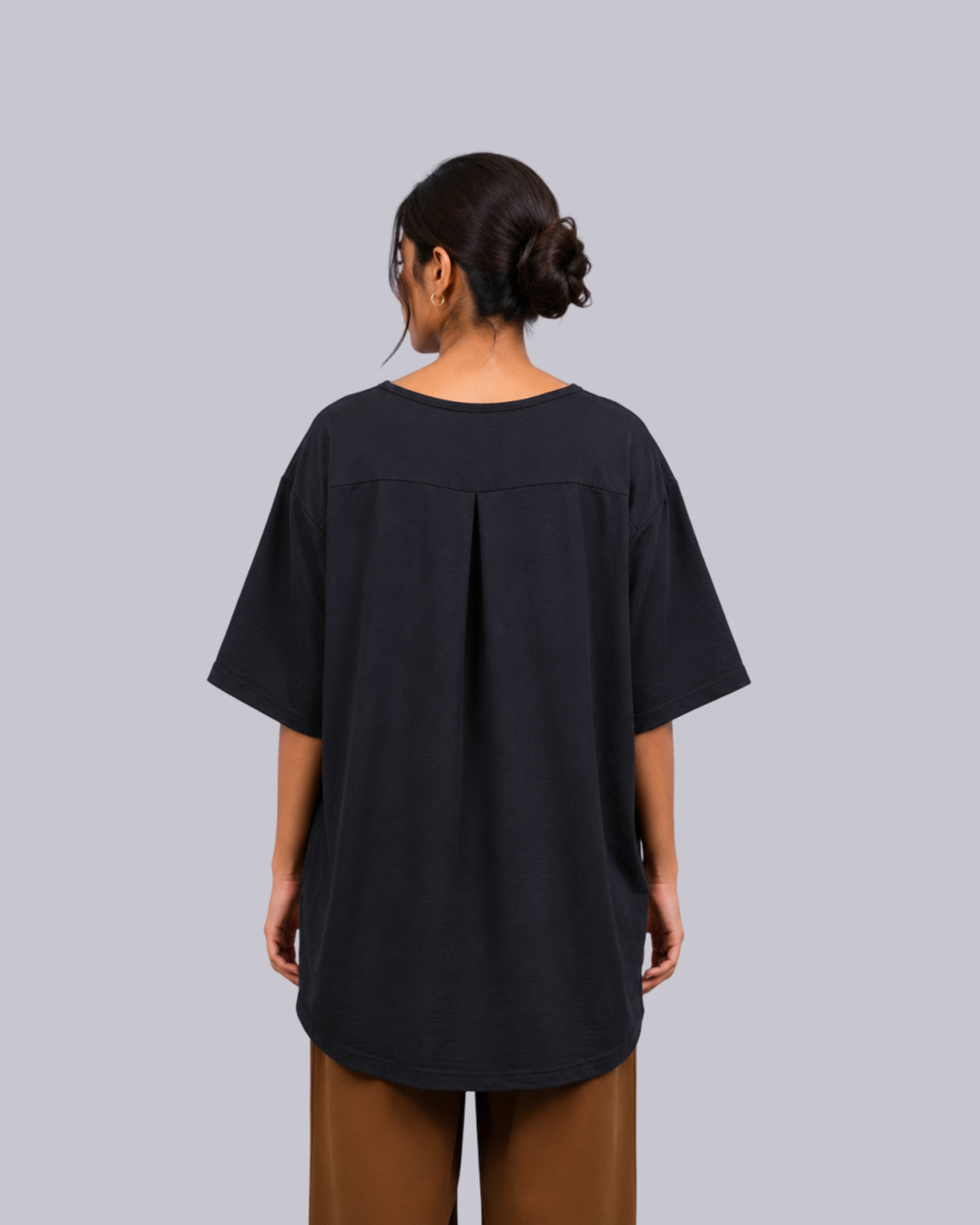 The back wearing an oversized black short-sleeve top