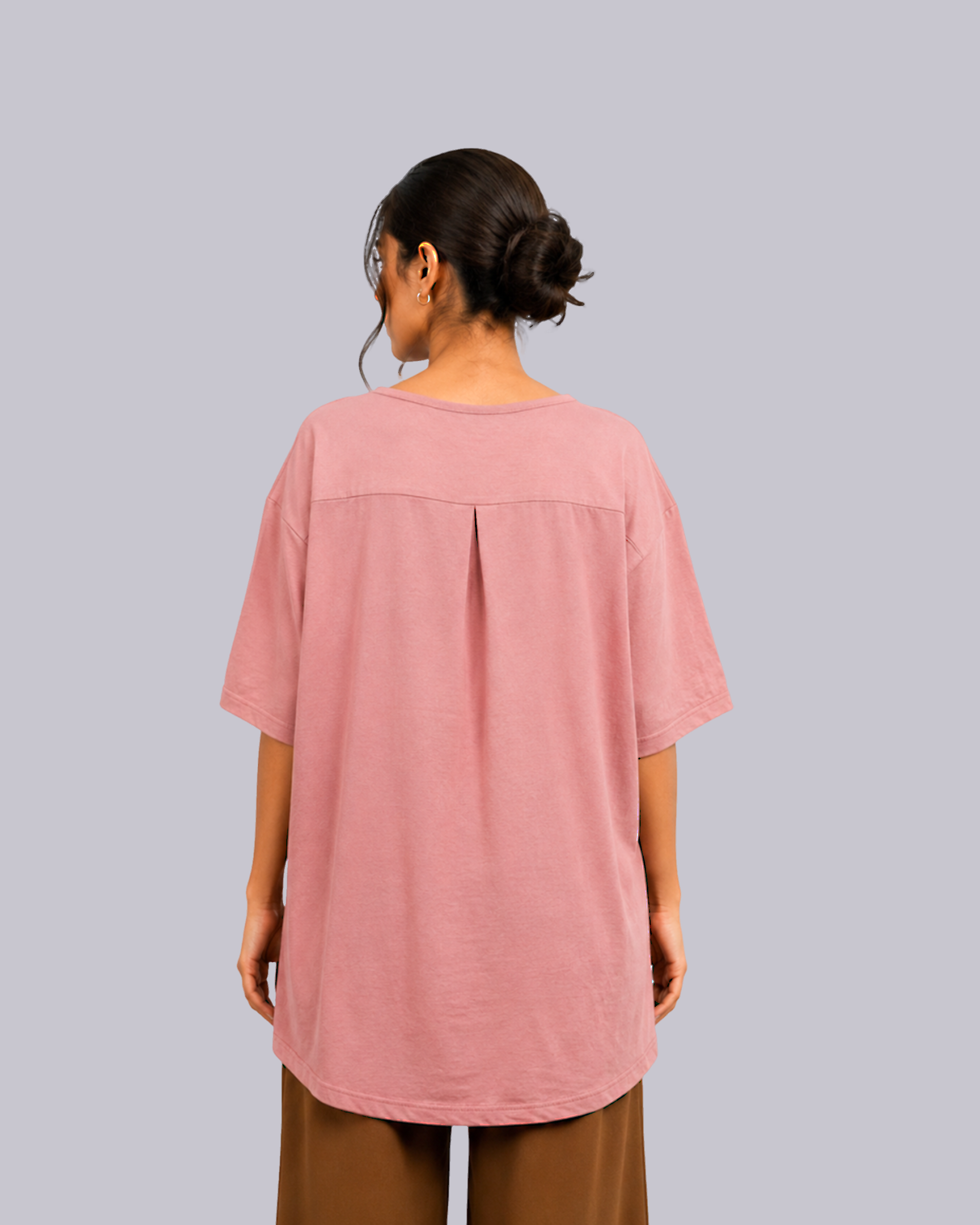 An oversized dusty pink short-sleeve top with a center back pleat