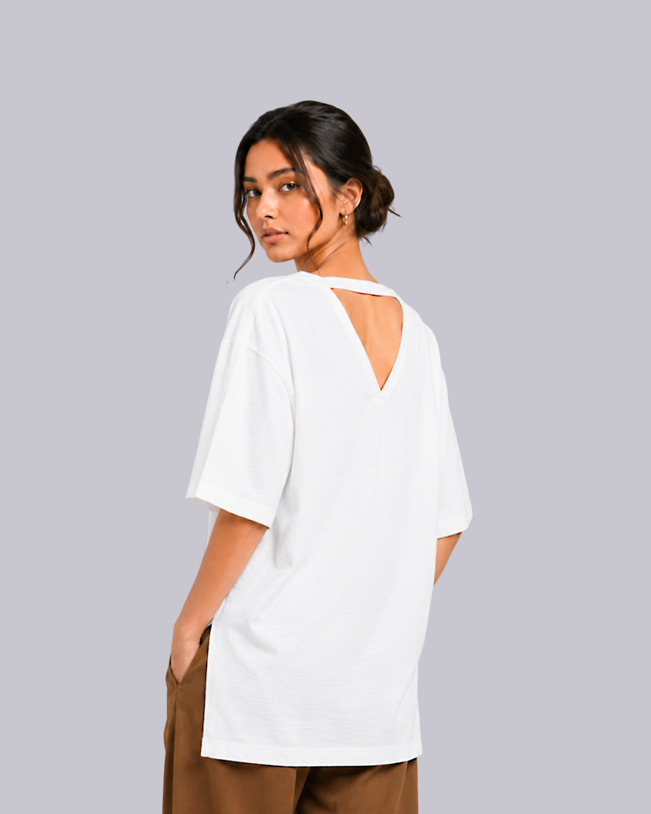 A woman wearing an oversized white short-sleeve t-shirt