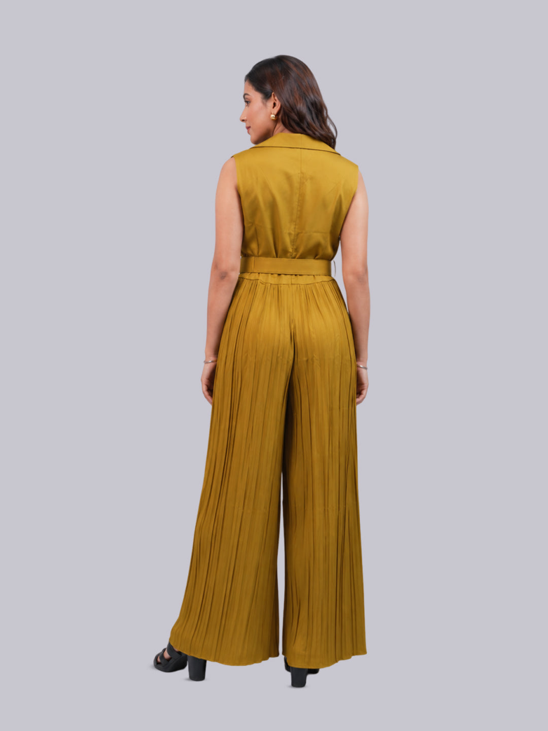 A sleeveless mustard yellow pleated jumpsuit with a collar