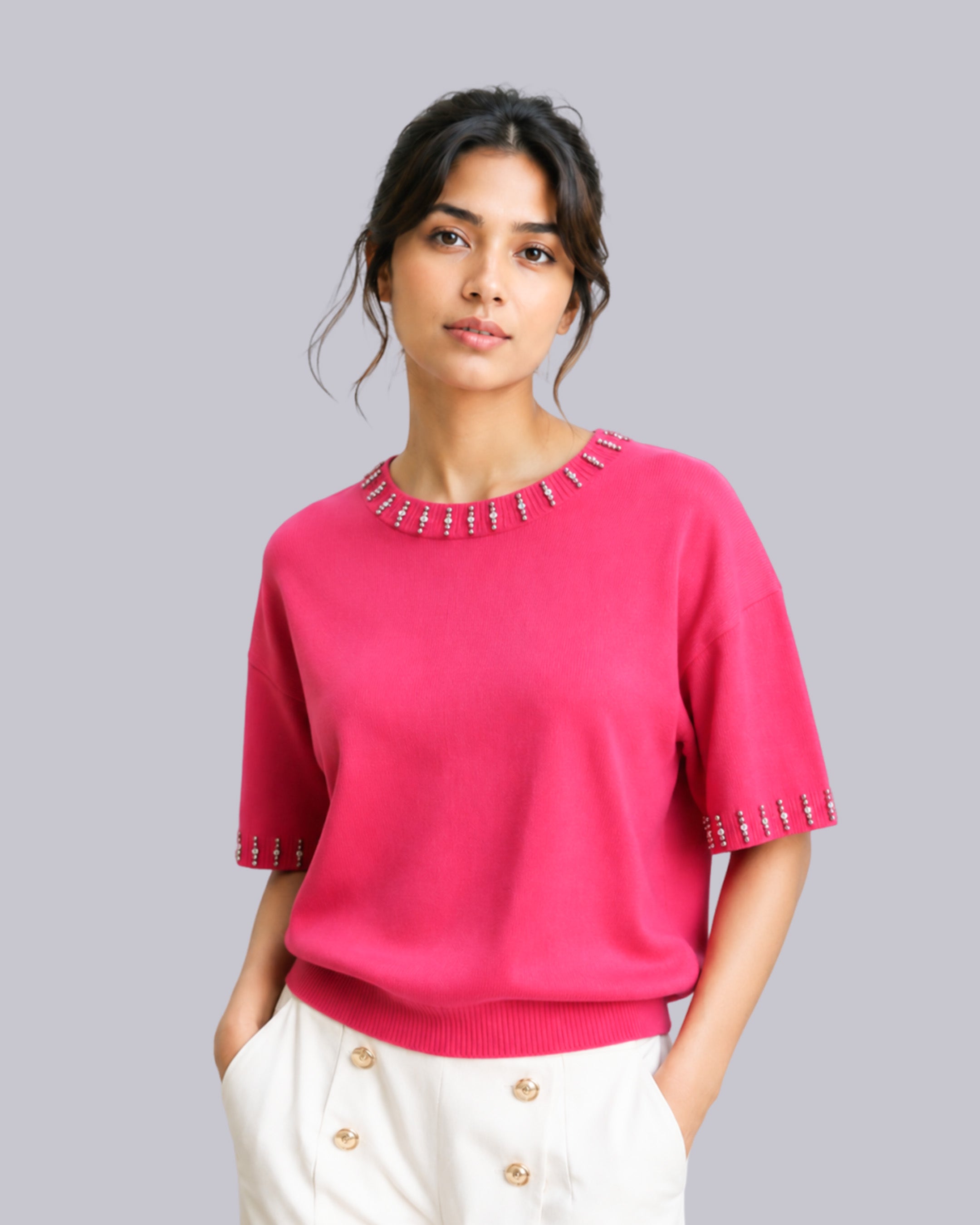 A woman wearing a bright pink short-sleeve knit top 