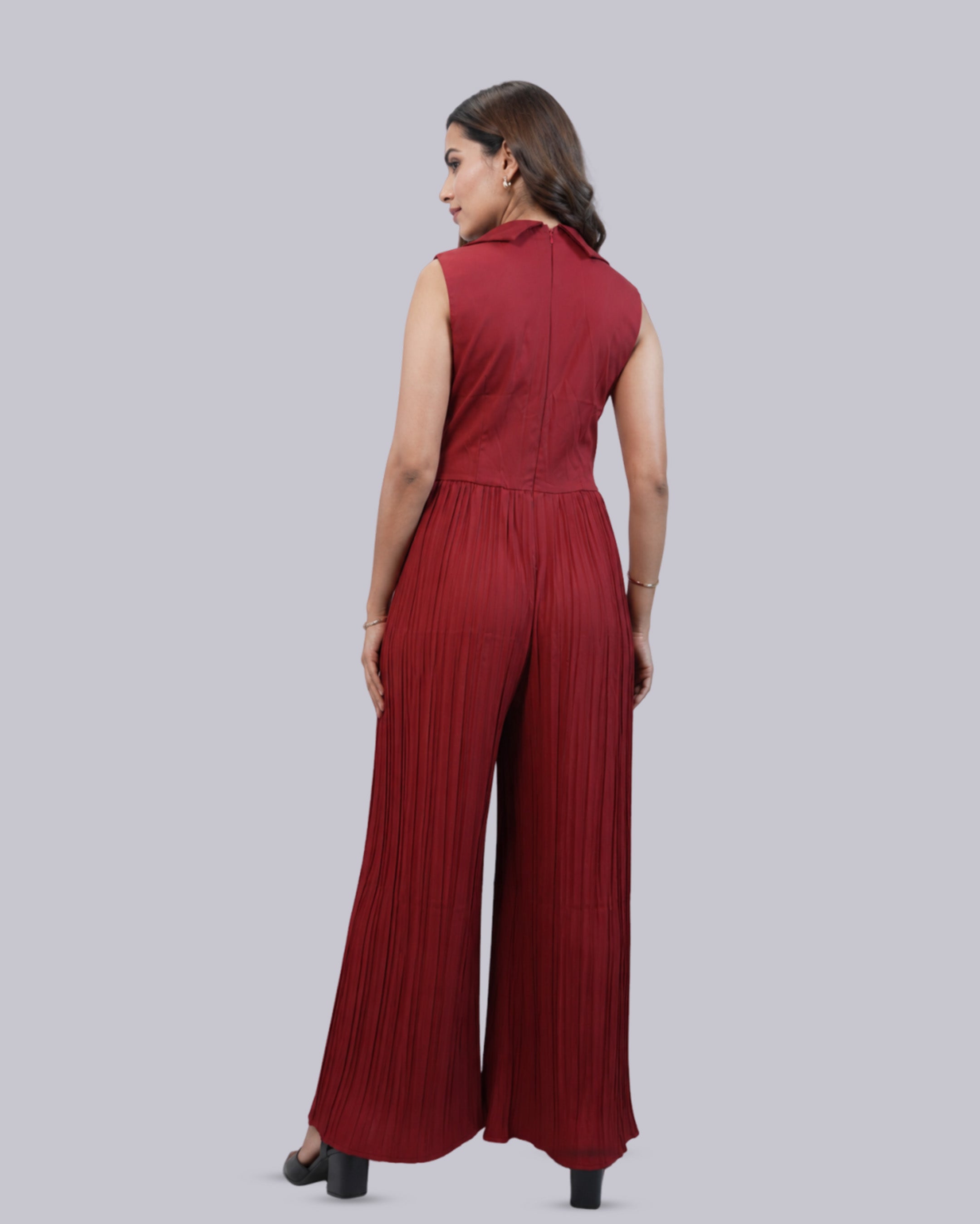 A sleeveless wide-leg jumpsuit in a deep red .
