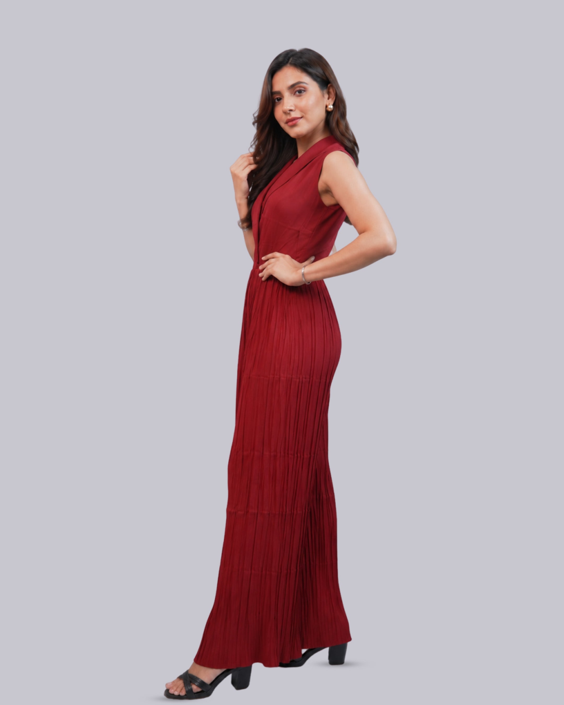 A woman modeling a sleeveless, one-shoulder maxi dress.