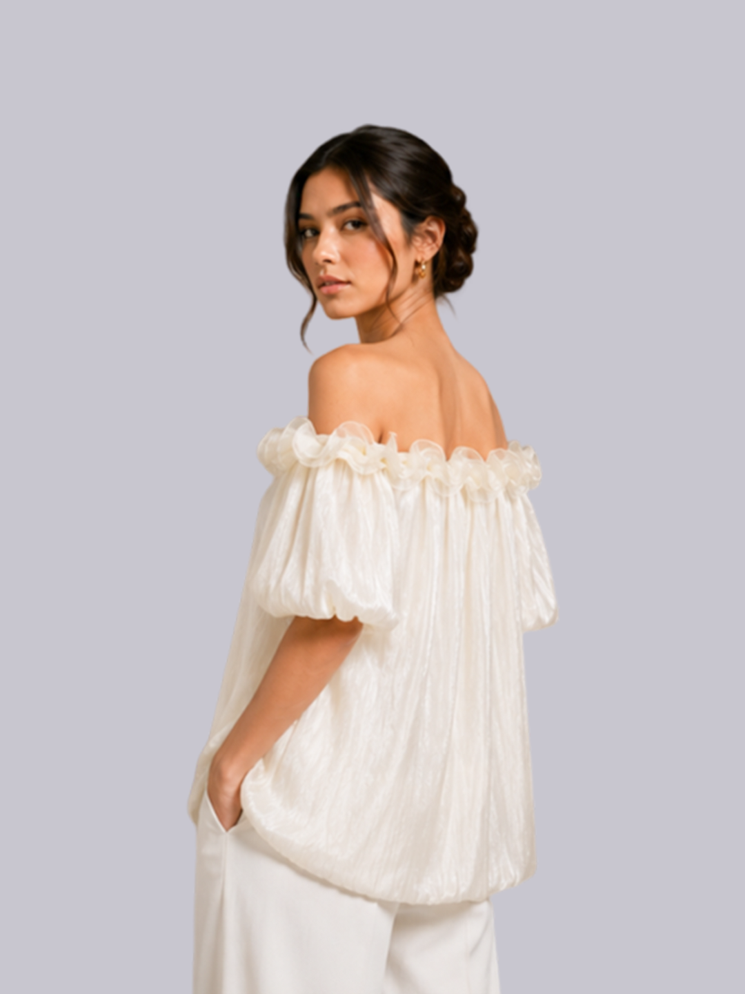A woman wearing an off-the-shoulder white blouse.
