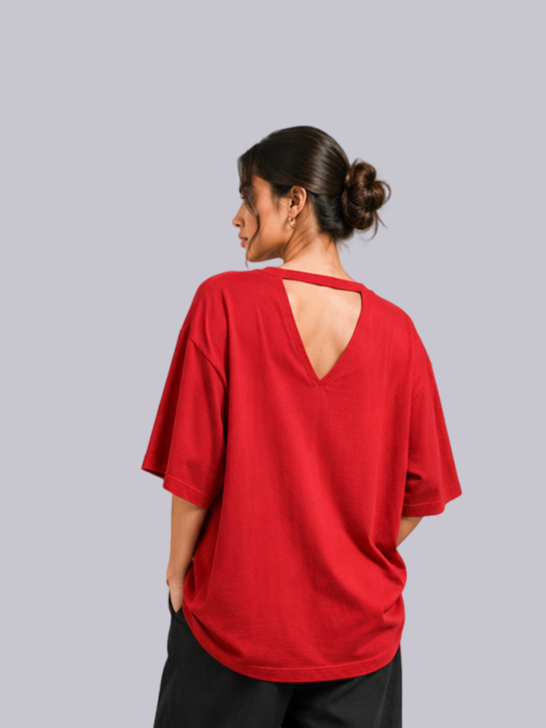 A woman shown from the back wearing a loose-fitting red short-sleeve top with a cutout neckline.