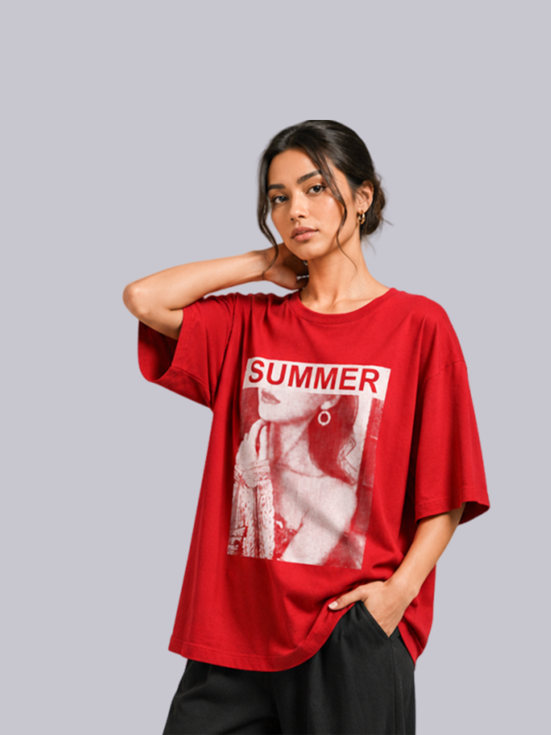 A woman modeling an oversized red graphic t-shirt.
