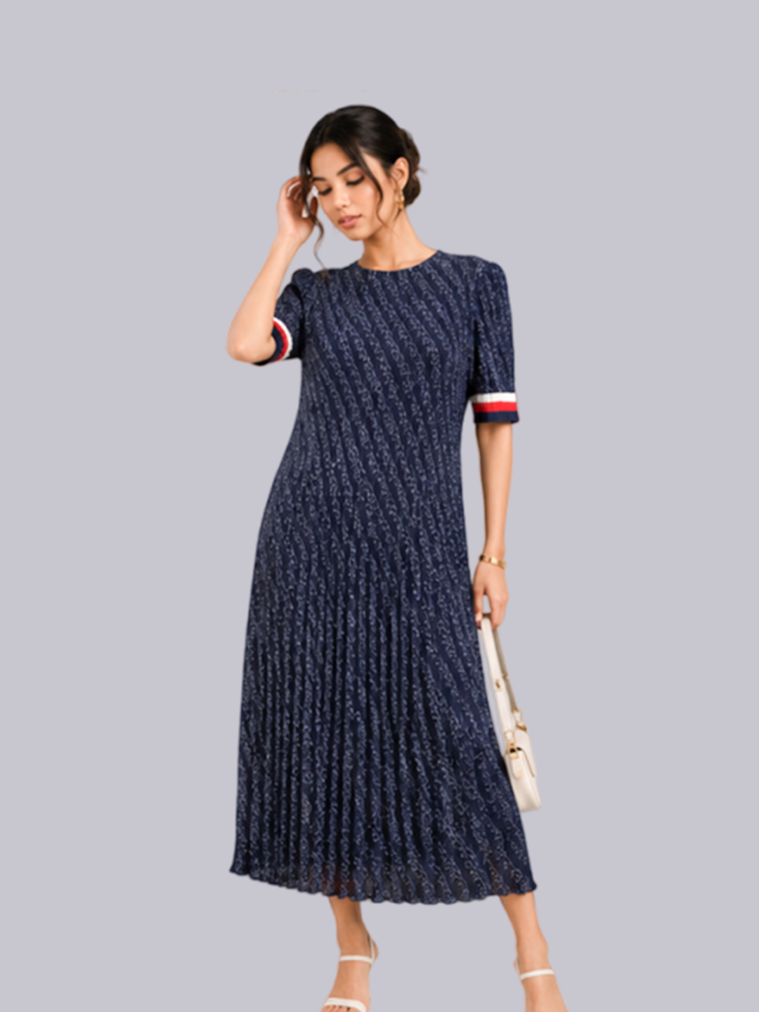 A woman modeling a navy blue midi dress with a textured vertical stripe pattern and short sleeves.