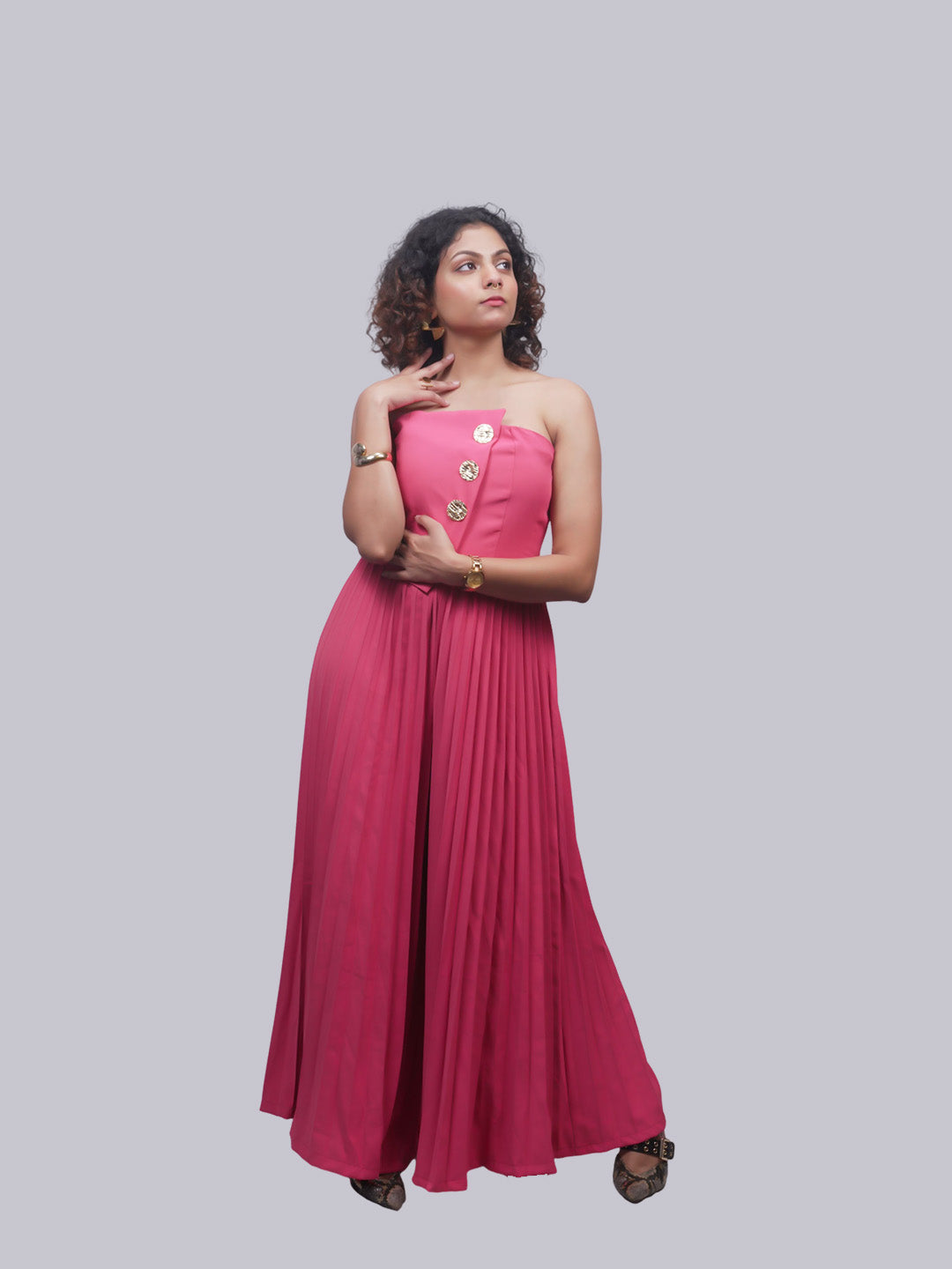 A woman modeling a strapless magenta-pink maxi dress.