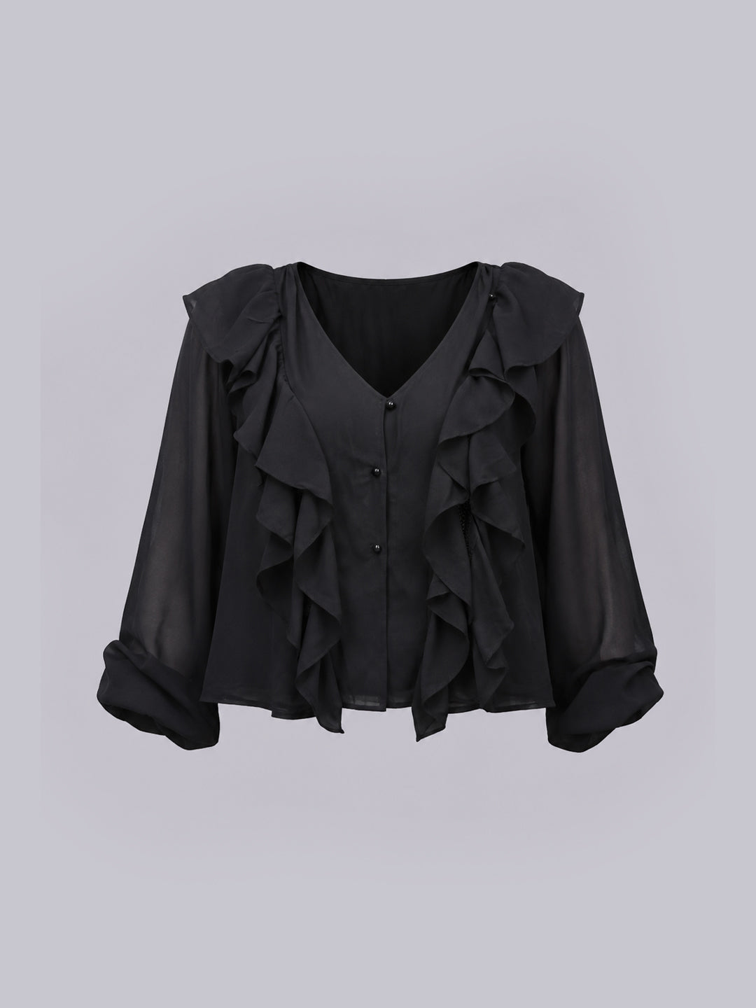 A black long-sleeve top with layered ruffles, a V-neckline.
