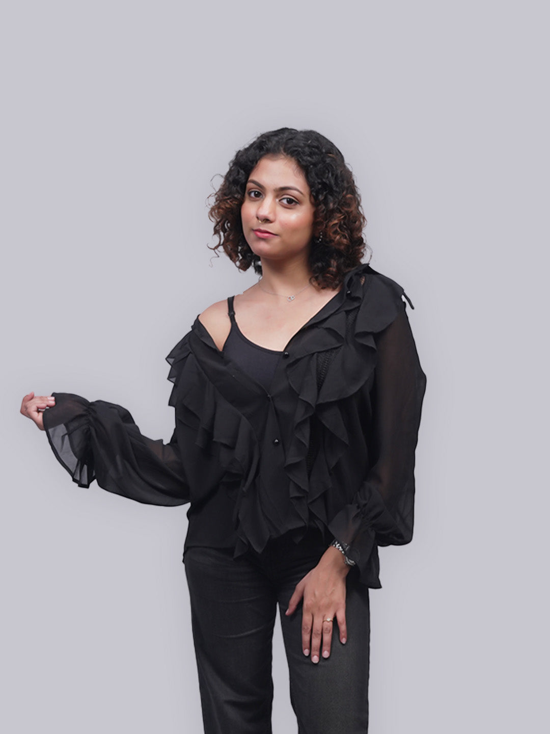 A black sheer ruffled long-sleeve top.