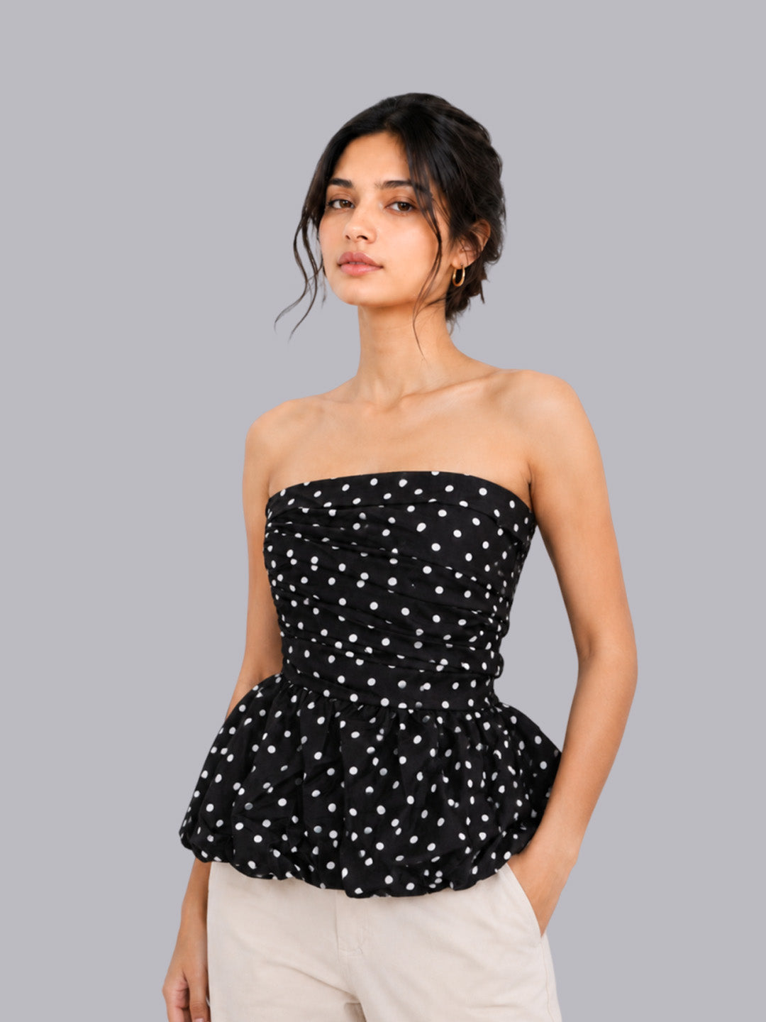 A black strapless peplum top.
