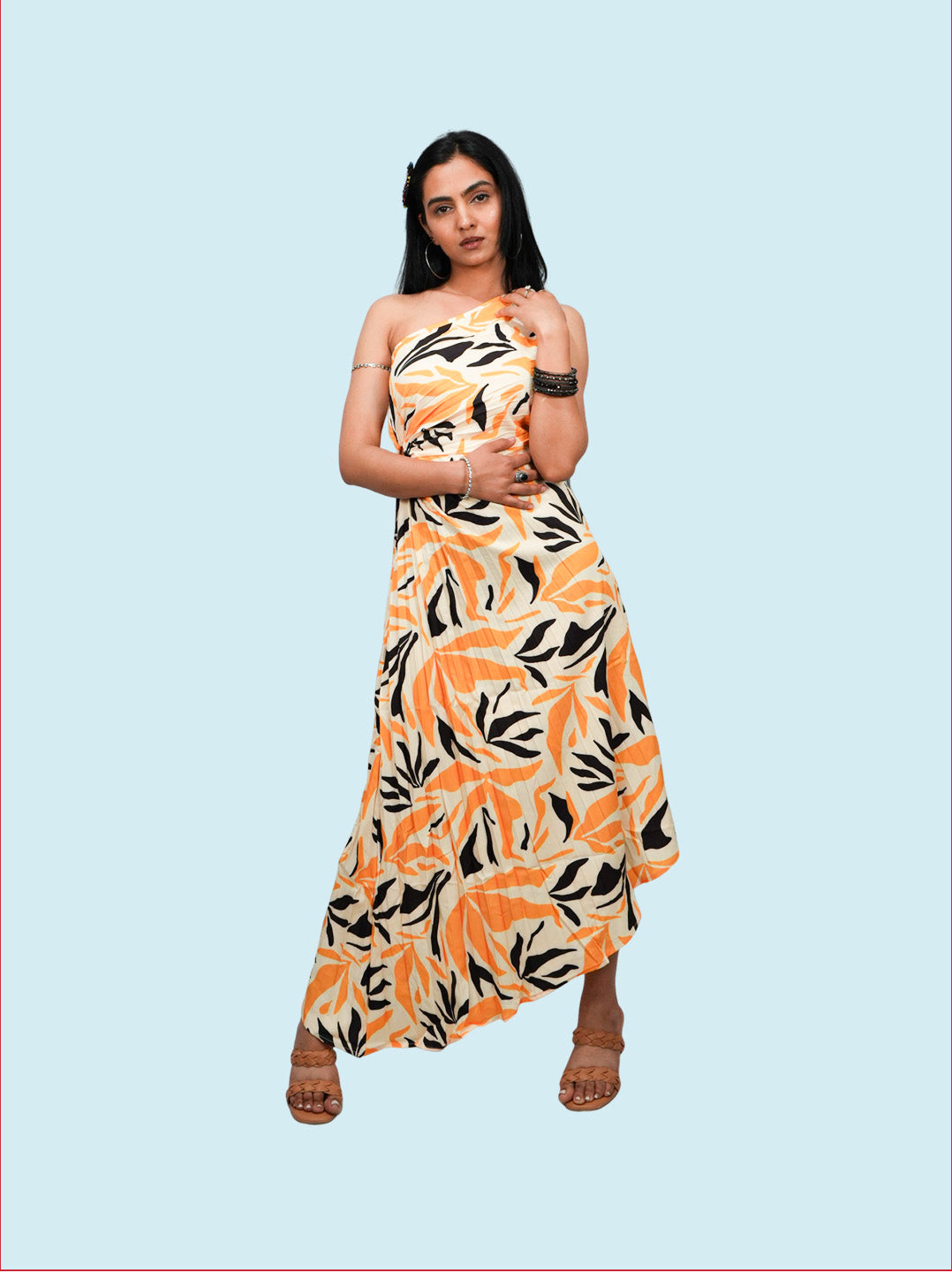 Woman wearing a floral dress with orange and black pattern