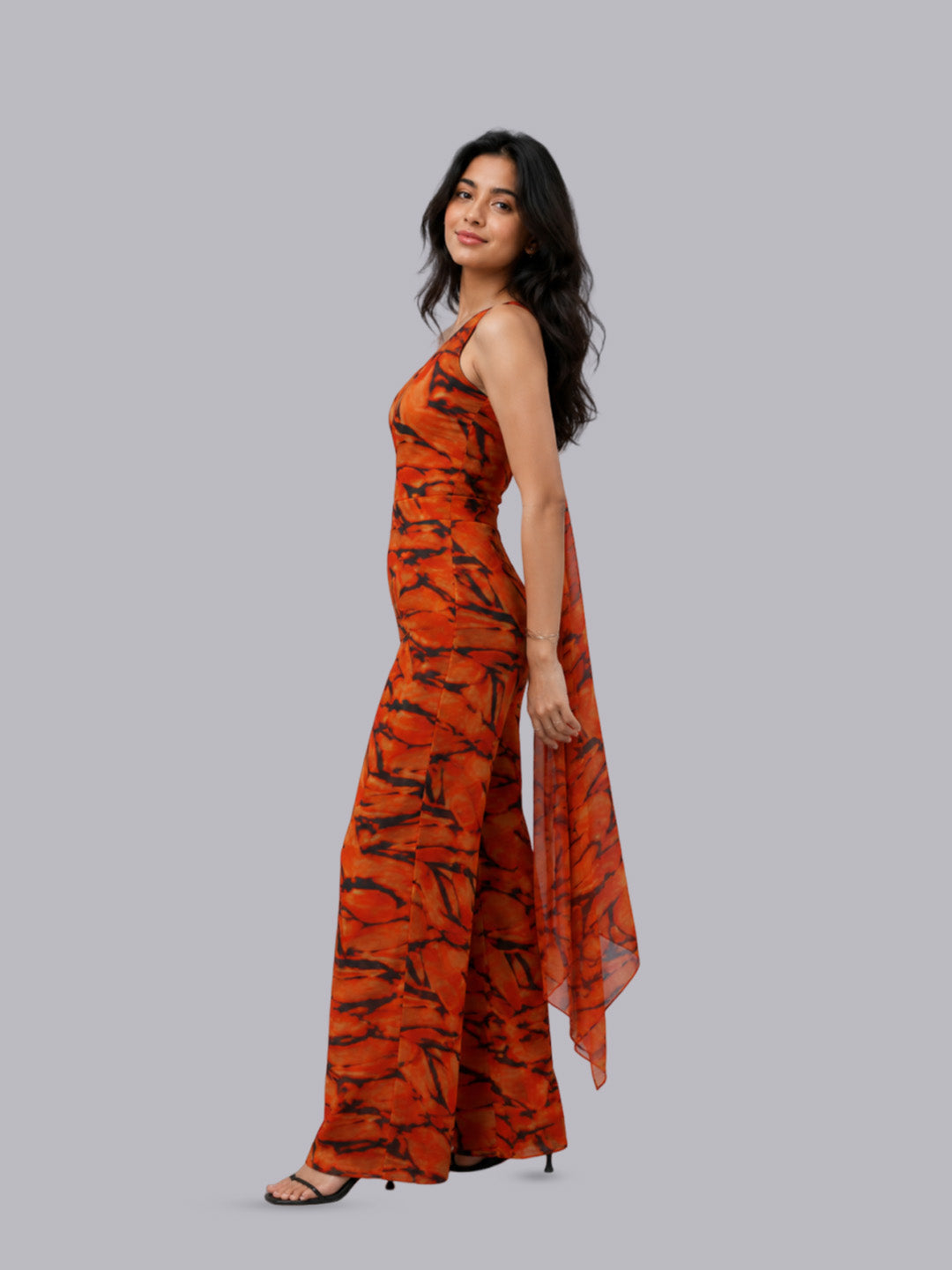 A sleeveless, floor-length orange dress with a black abstract tiger-stripe pattern.