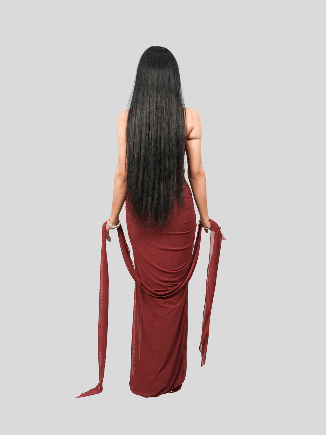 Woman wearing a burgundy dress with a draped design