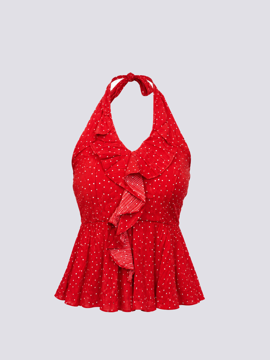 A red halter-neck top with a white polka dot pattern, featuring a ruffled collar and a matching ruffled tie detail at the waist, shown against a solid light gray background.